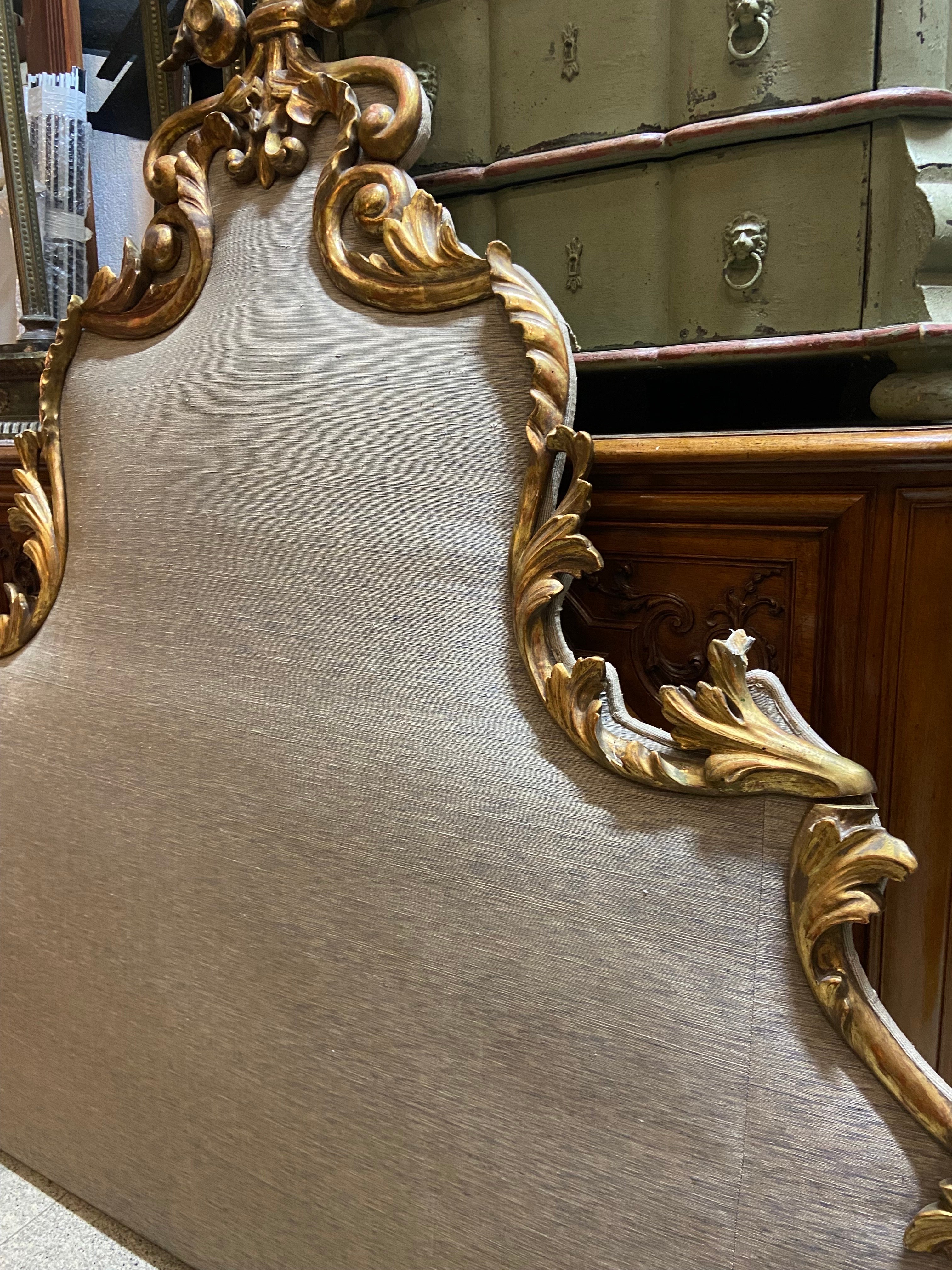 Here we present a late 19th century queen size headboard featuring deeply scrolled, hand carved leaves wearing the original paint and naturally time aged patina. It was made in France in Rococo style and is in very good authentic condition. There is