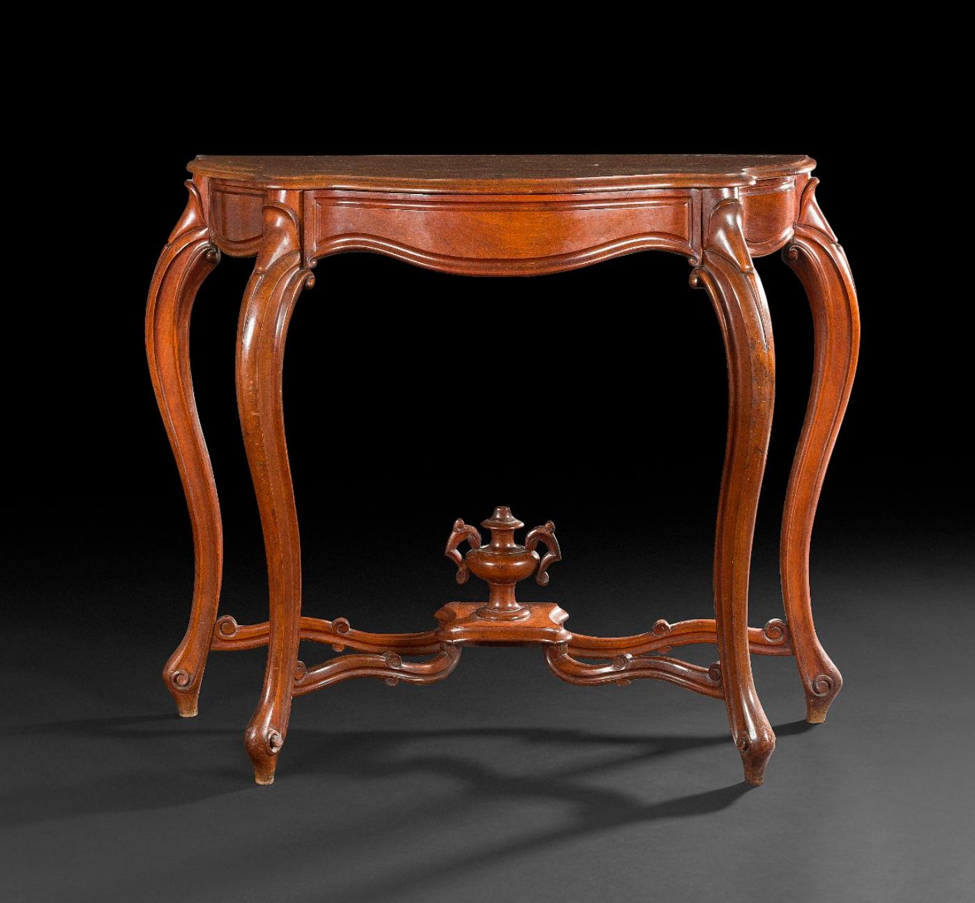 Mahogany console molded and carved form of movement, opening to one drawer, resting on arched legs joined by a spacer surmounted by a vase.
France, circa 1880.