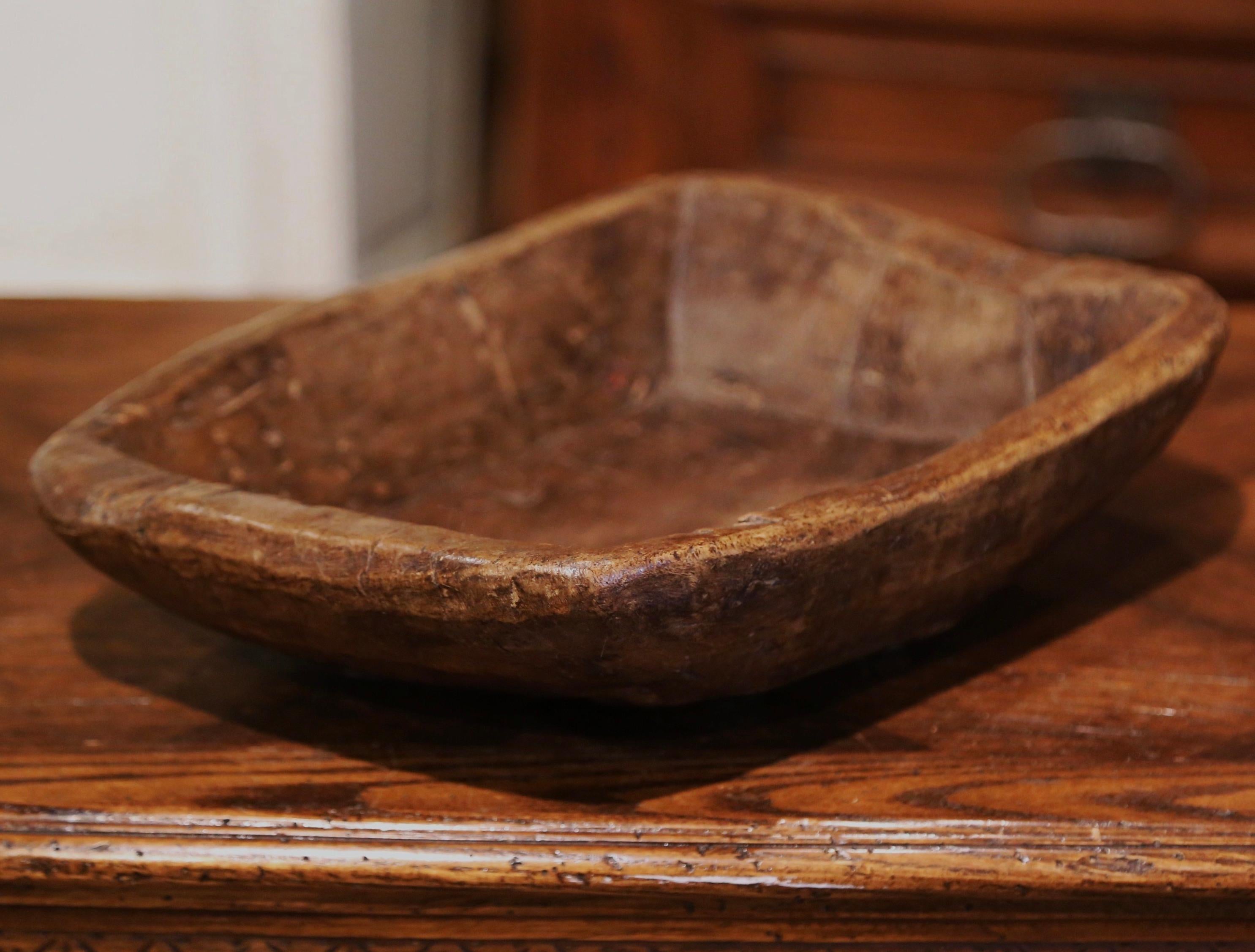 Fill up this elegant antique bowl with fruit or vegetable and use it as a center piece on a dining room table or kitchen counter! Hand carved in France circa 1870 and built of oak wood, the large bowl is rectangular in shape and adorns a rich walnut