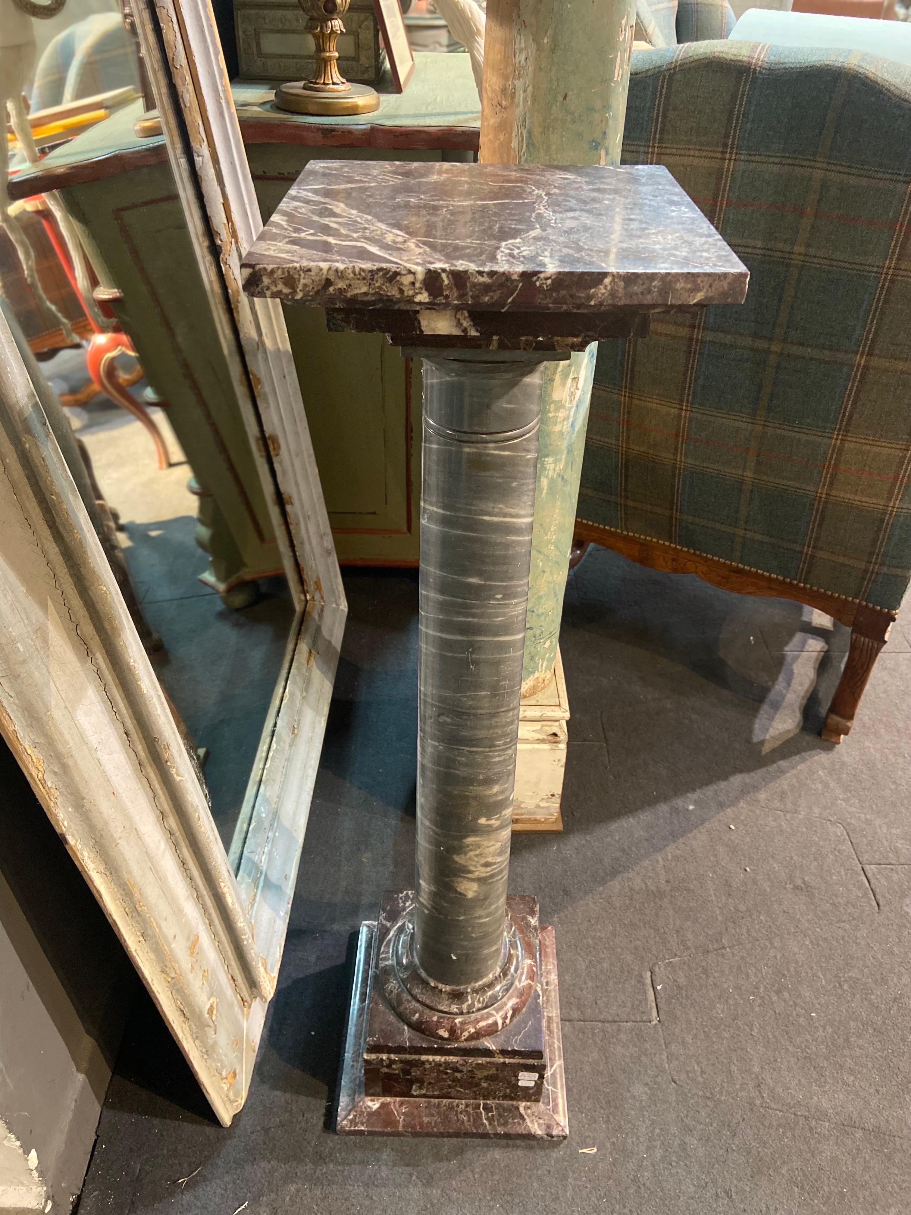 Hand carved marble column pedestal made of combination of red and grey marble with square head standing on a square, terraced base. 
Napoleon III style
France, circa 1890.