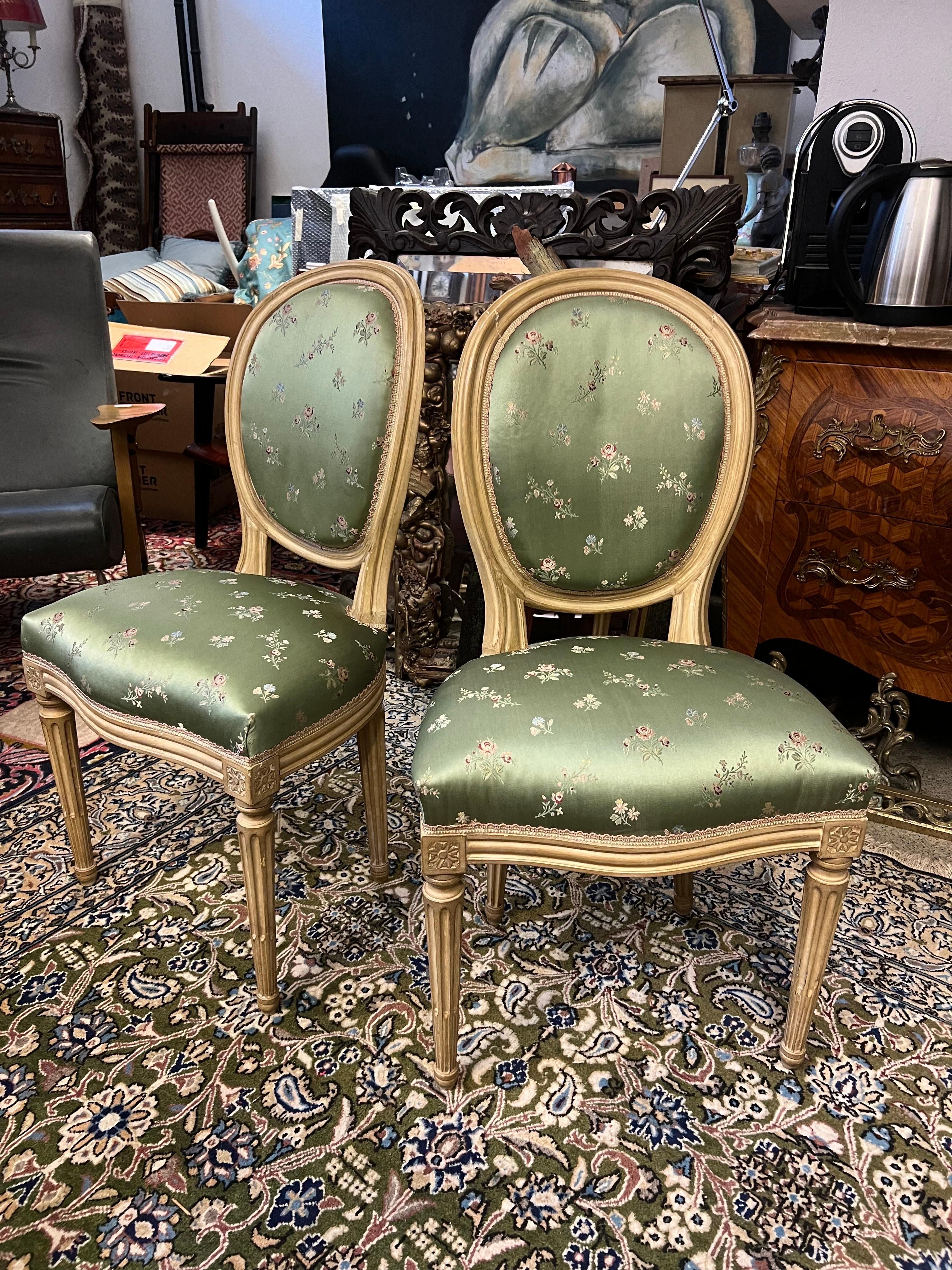 19th Century French hand carved and painted in light beige side chairs in Louis XVI style recently reupholstered in Lelievre silk in green covered with small colourful flowers.
Very stable structure and lovely oval shape of the backs.
Great carvings