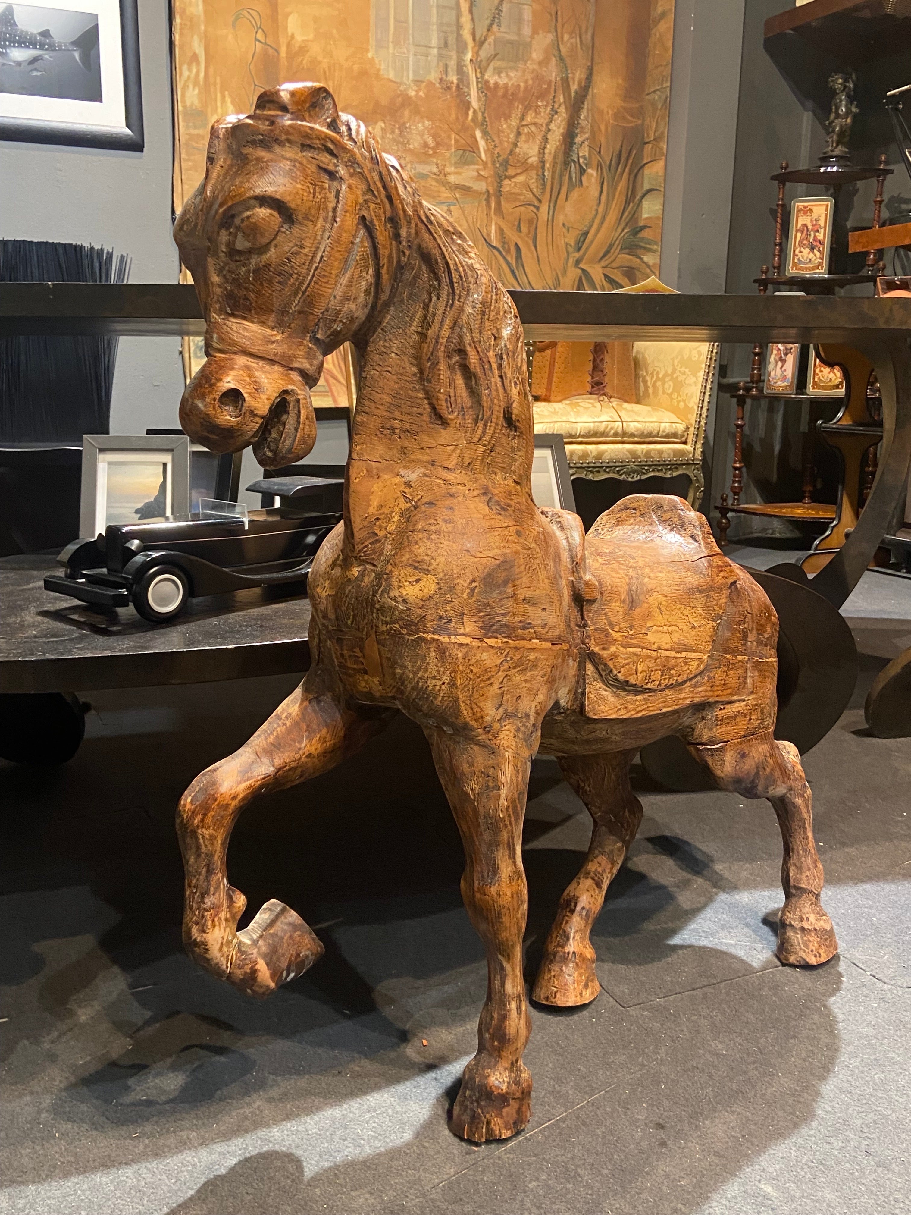 Lovely French hand carved small carousel horse made in late 19th century. It was never painted and has few small scratches and missing pieces but is in quite good overall condition. Could not stay raised without being suported.
France, circa 1880.