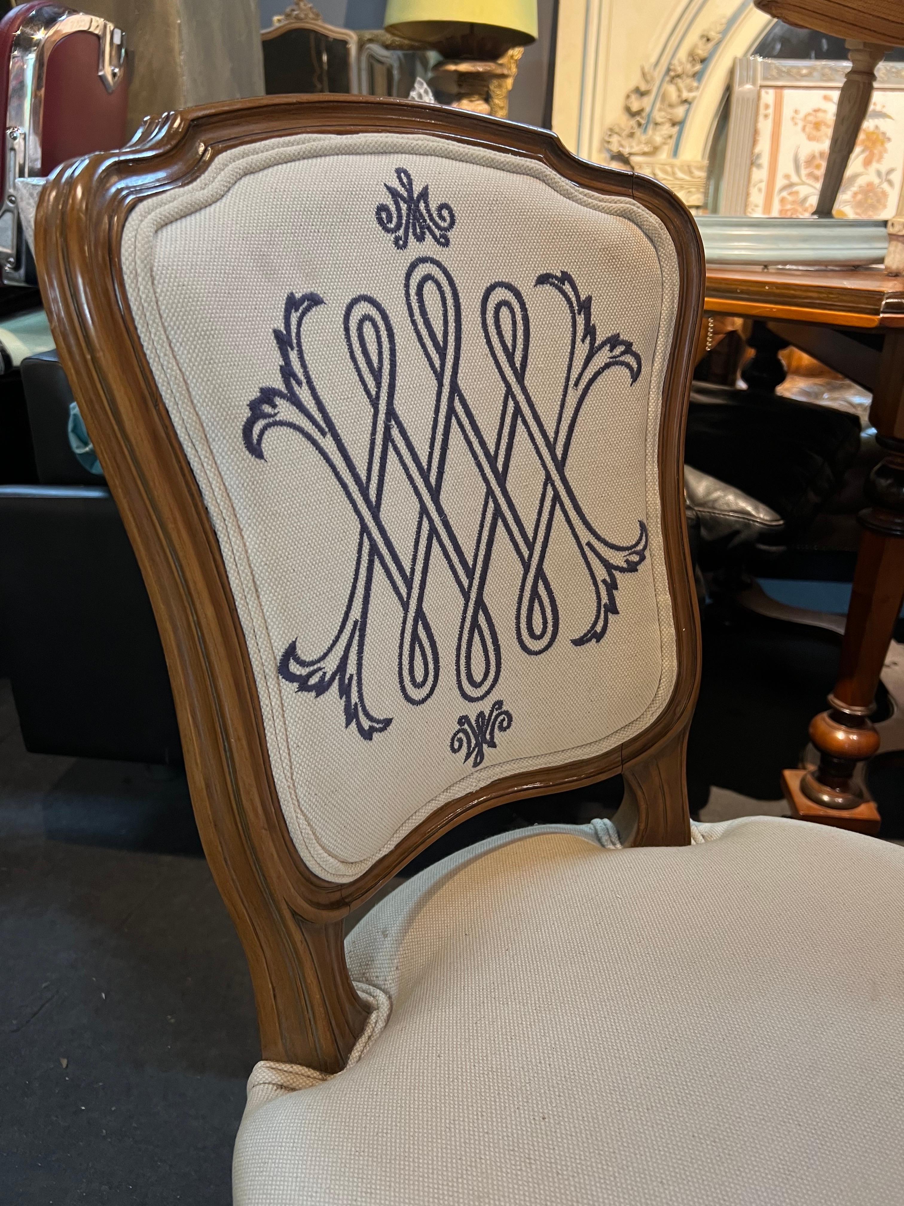 19th Century French hand carved walnut chair with beige linen upholstery. There are nice monograms on both front and back side of the chair. There are three other chairs with different frames but same upholstery.
Made in France, circa 1900
