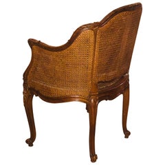 19th Century French Hand Carved Walnut Ladies Armchair in Caned Back and Seat