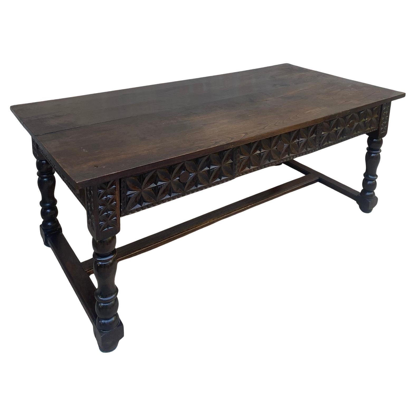 Found in the South of France, this 19th century hand carved French walnut table or desk can be placed in the middle of a room as it is beautifully carved on all sides. It features a beautiful solid wood top in a walnut colour, over two large front