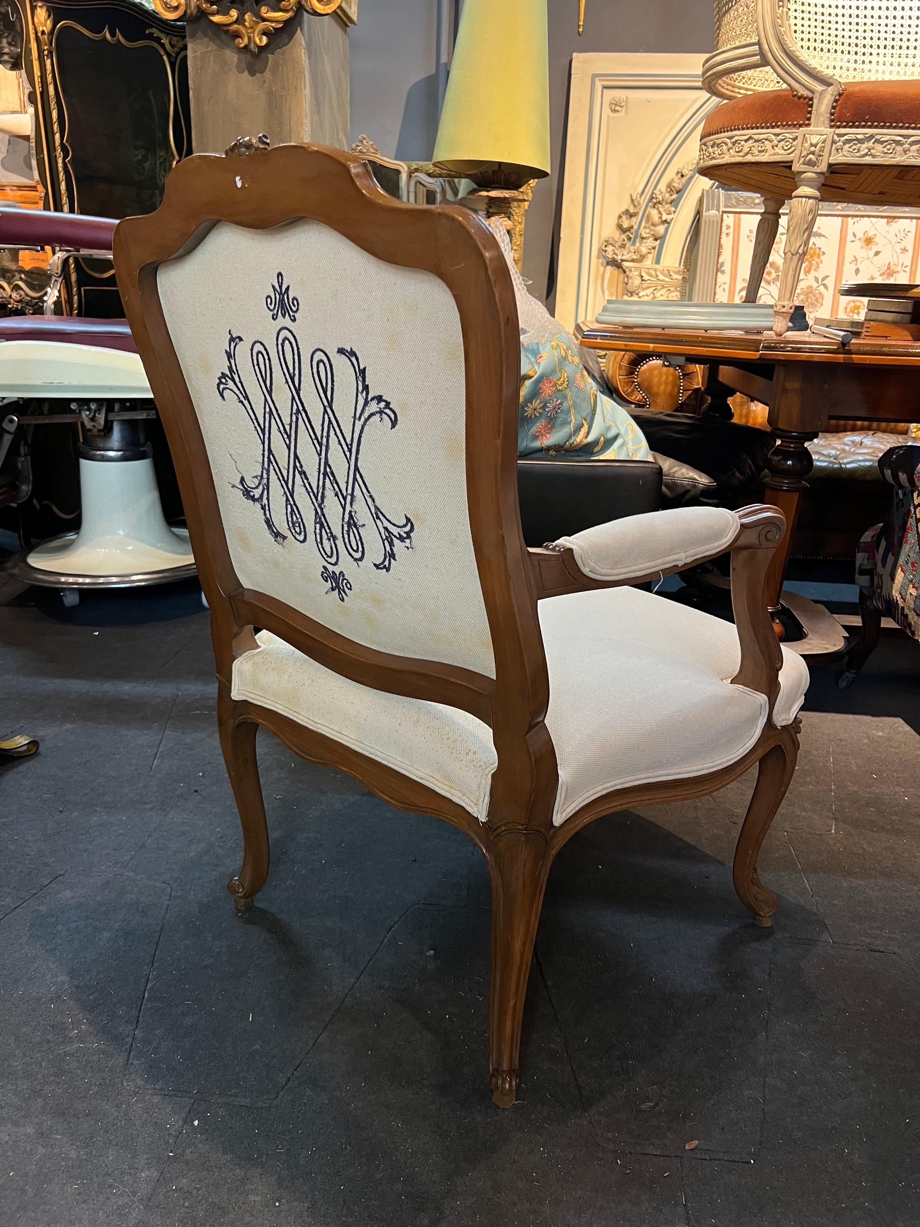 19th Century French hand carved walnut armchair with beige linen upholstery. There are nice monograms on both front and back side of the chair. There are three other chairs with different frames but same upholstery.
Made in France, circa 1900