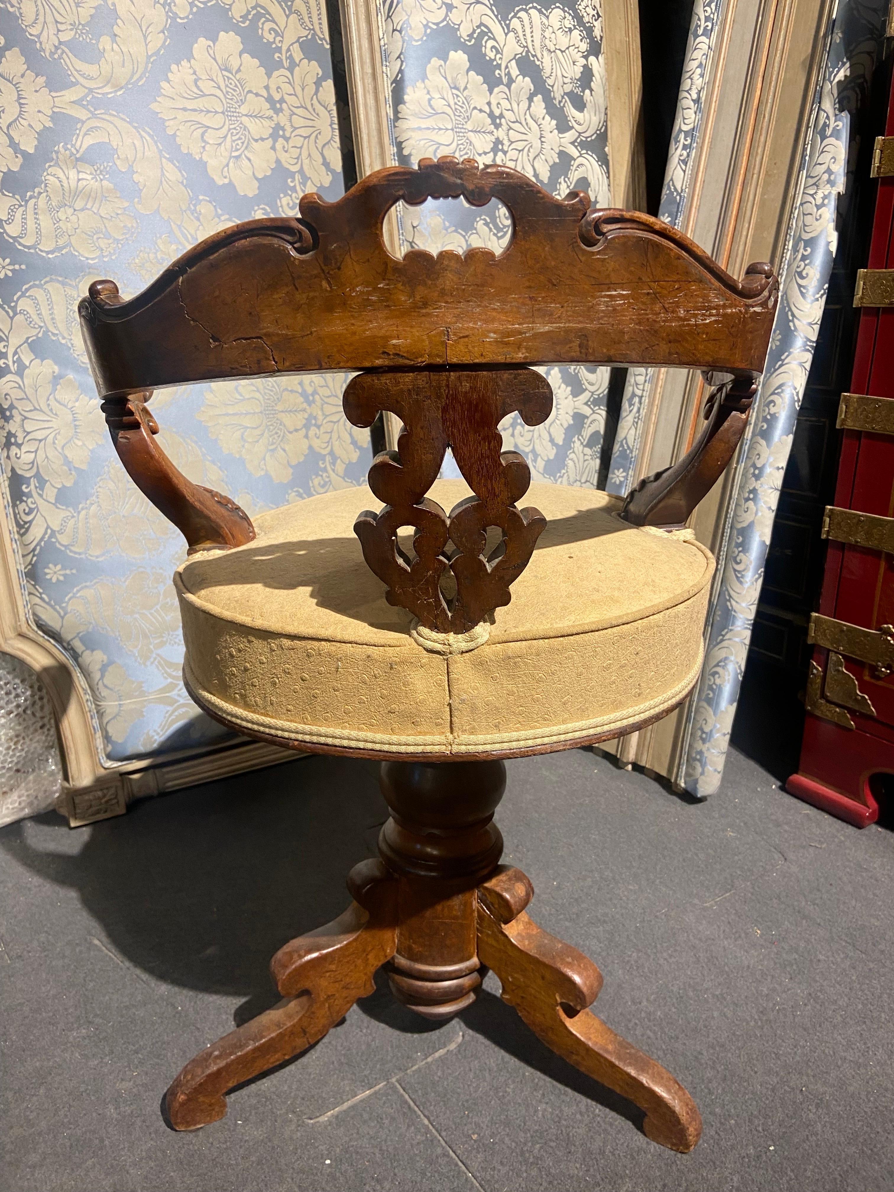 Very delicate and rare hand carved wooden piano swivel chair made in mid 19th century during Napoleon III period. Having no restoration so far the chair is even still wearing in its original ostrich upholstery. The back of the chair is curved and