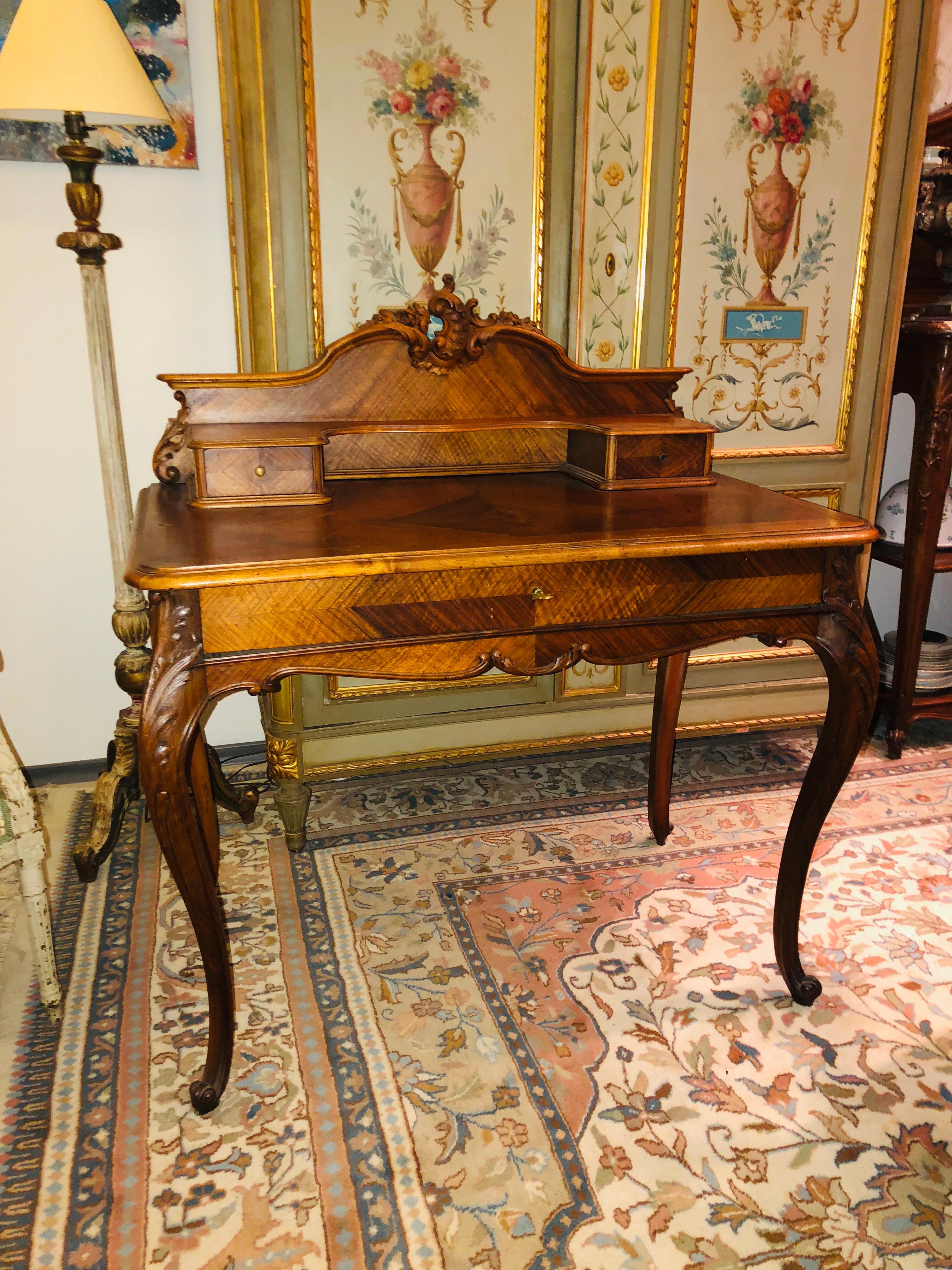 French writing desk in Louis XV style, made in natural wood surmounted by a step opening with two drawers and also opens to a drawer in a belt. 
France, circa 1890
Measures: H 110, L 100, W 59.5 cm.