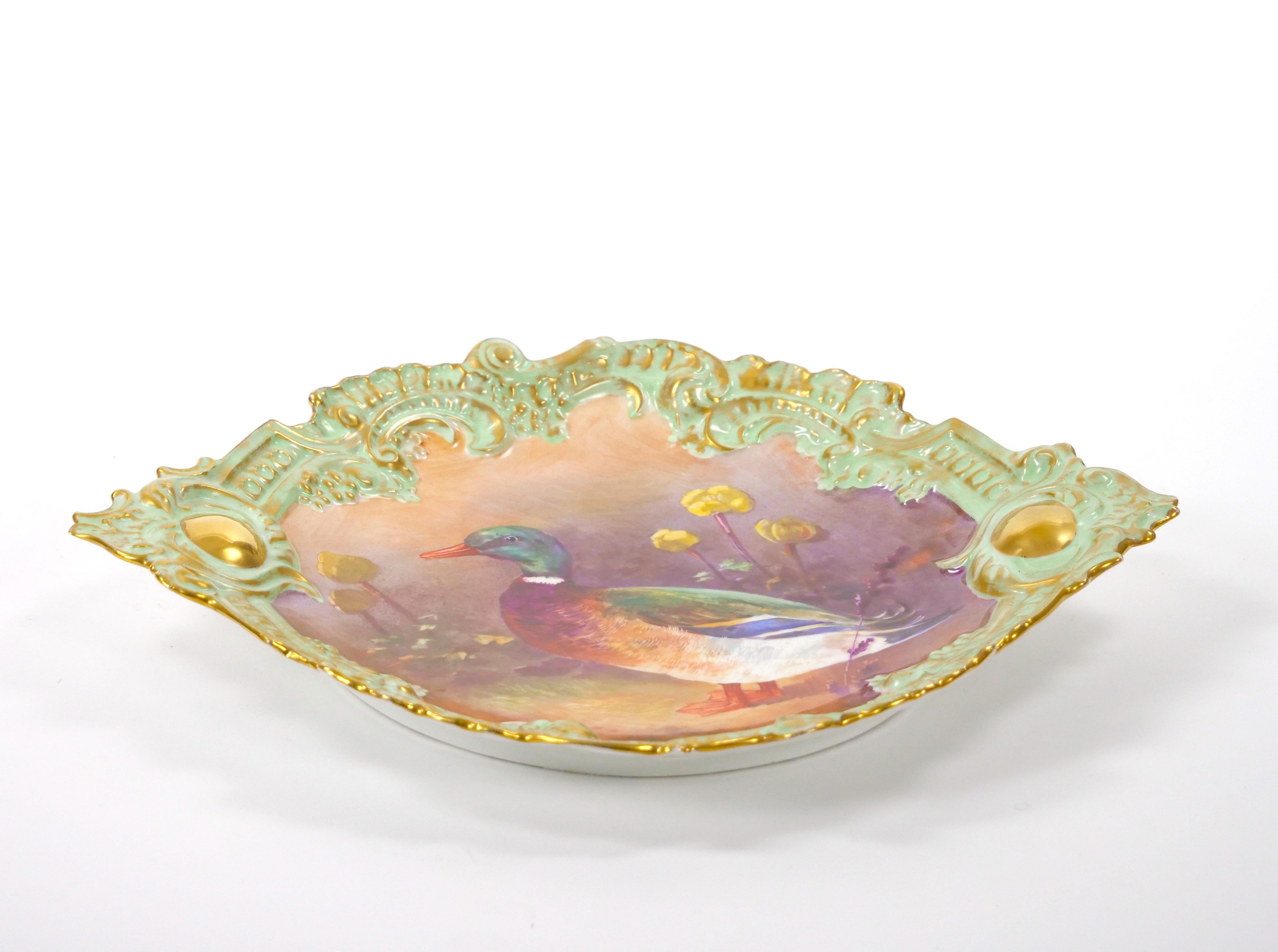 Transport yourself to the elegance of early 19th-century France with this exquisite hand-painted and gilt gold decorated porcelain wall plate, crafted by renowned artisans in Limoges, France. A testament to the era's artistic finesse, this