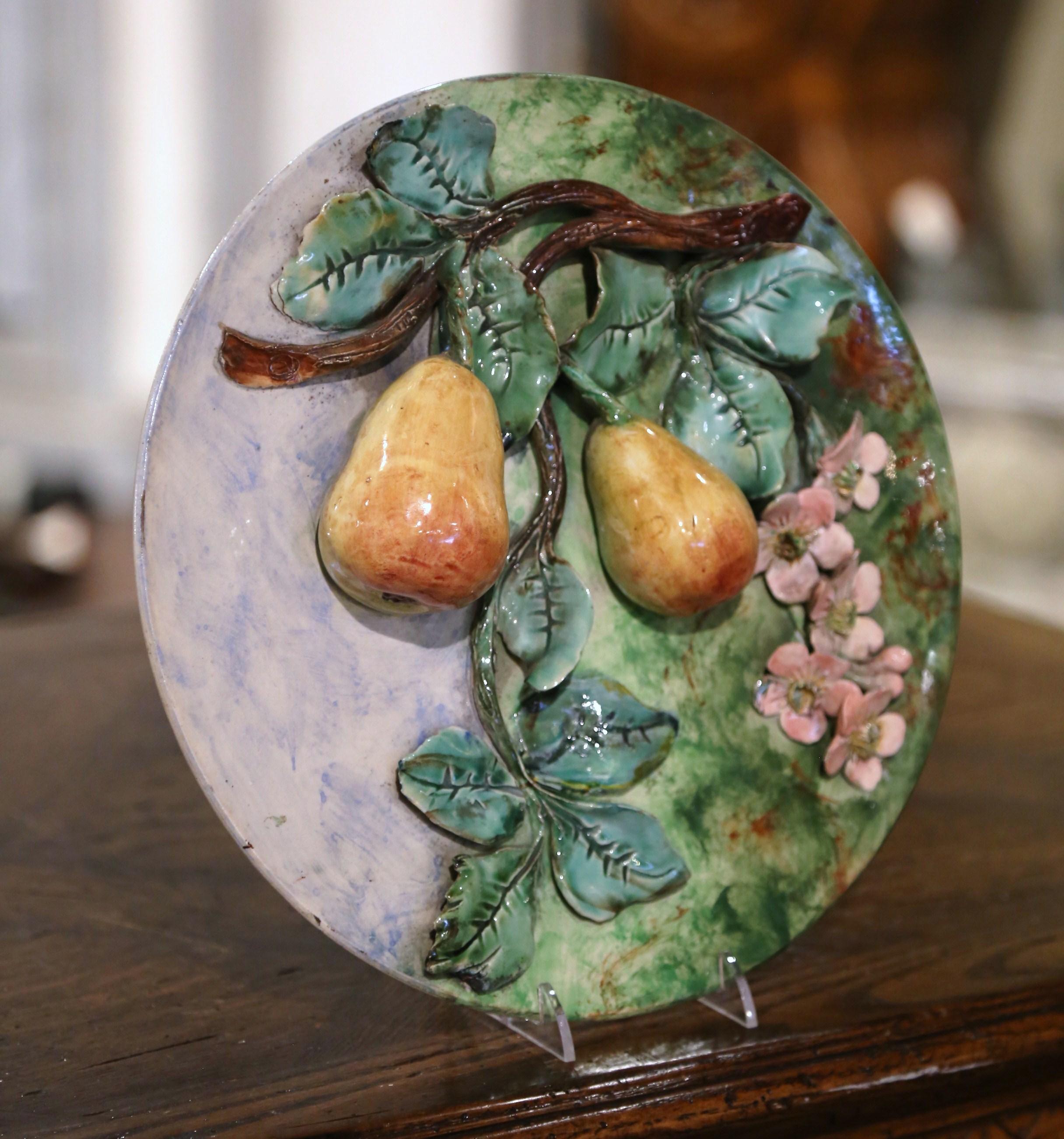 Add some color to your kitchen wall or dining room shelf with this beautiful antique Majolica wall platter. Crafted in France, circa 1880, the plate features sculptural fruit motif in high relief which includes a pair of pears hanging from tree