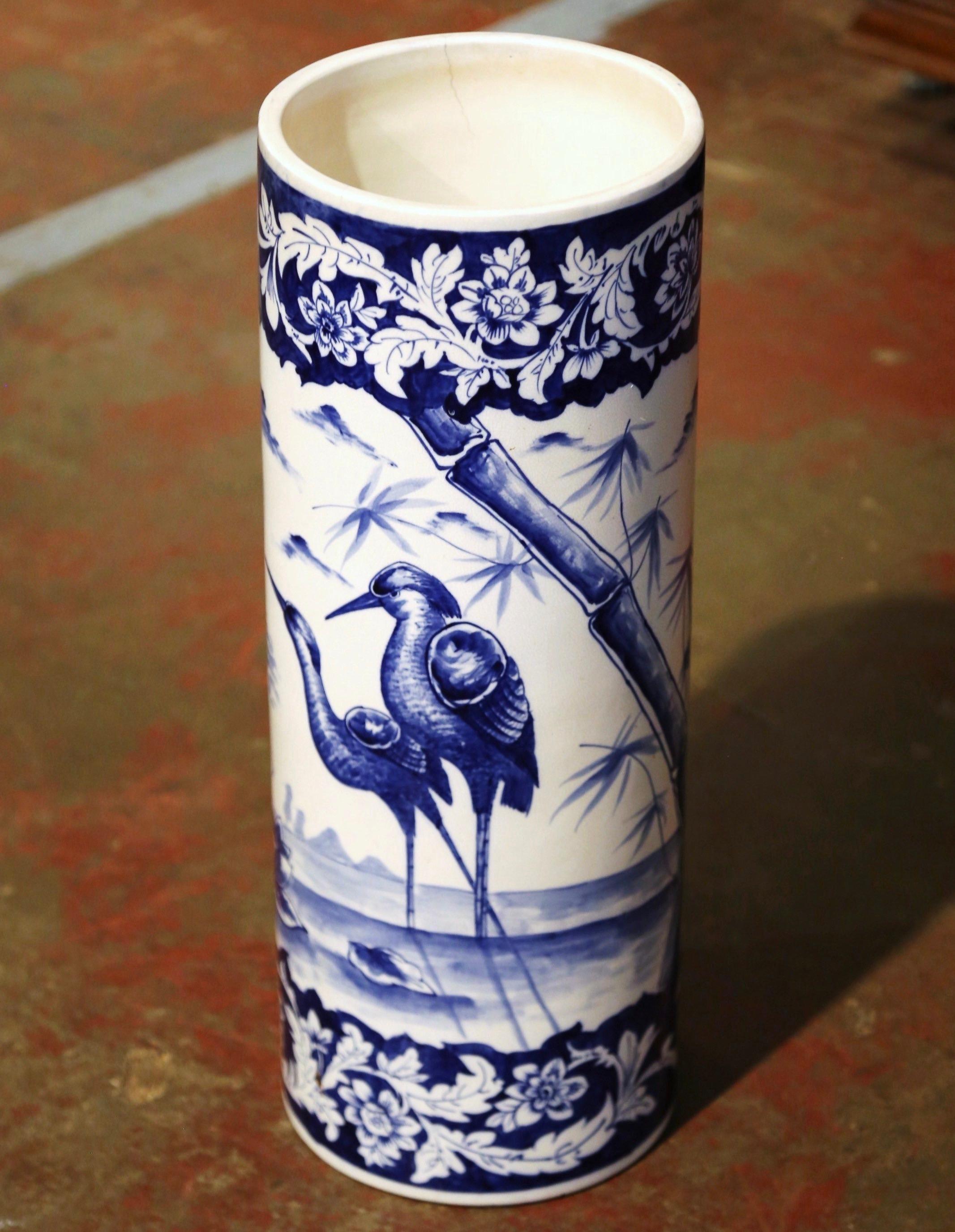 Place this tall, elegant stand at your front door or in your mudroom to catch loose canes and umbrellas. Crafted in France, circa 1880, the circular porcelain umbrella holder features a colorful hand painted pastoral scene with herons onshore; it is
