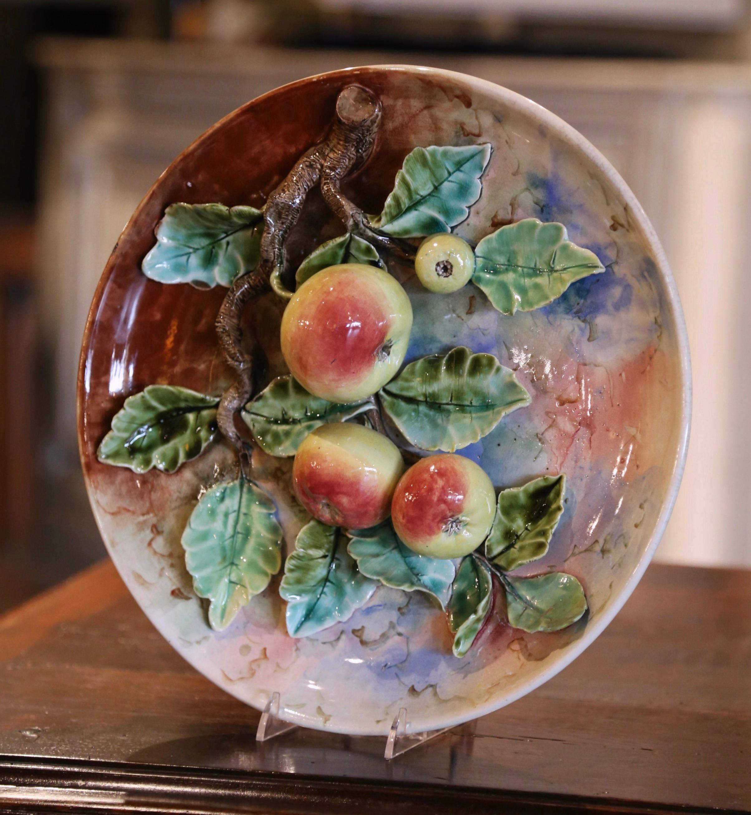 Decorate a kitchen wall or a breakfast room with this large antique majolica plate. Sculpted in France circa 1880 in the manner of Longchamp, the colorful porcelain platter is decorated with hand painted fruit motifs in high relief including four
