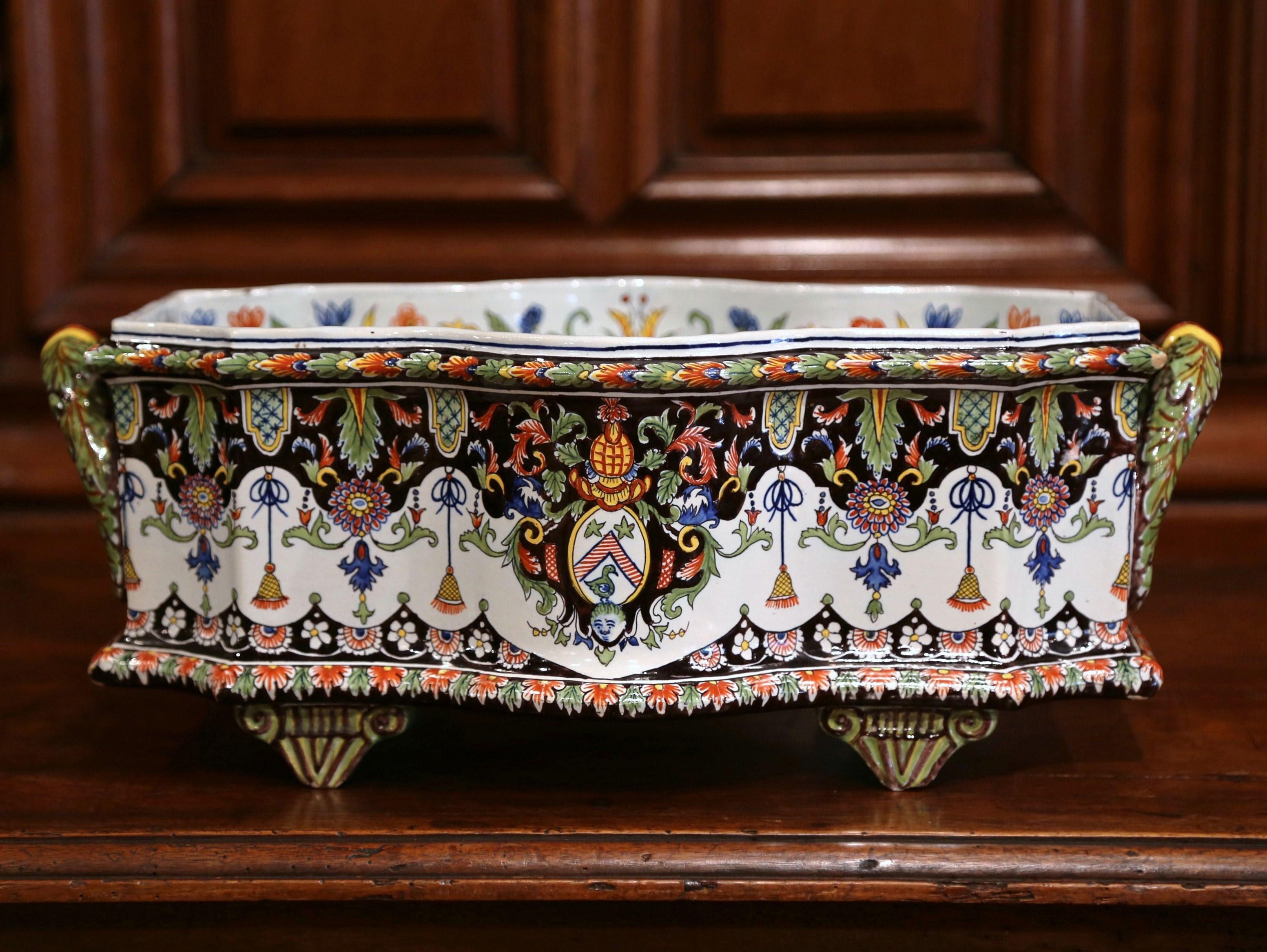 Decorate a mantel or a dining room table with this colorful antique jardinière. Crafted in Rouen, Northern France circa 1890 and rectangular in shape, the ceramic planter stands on four small tapered feet and is embellished with side handles. The