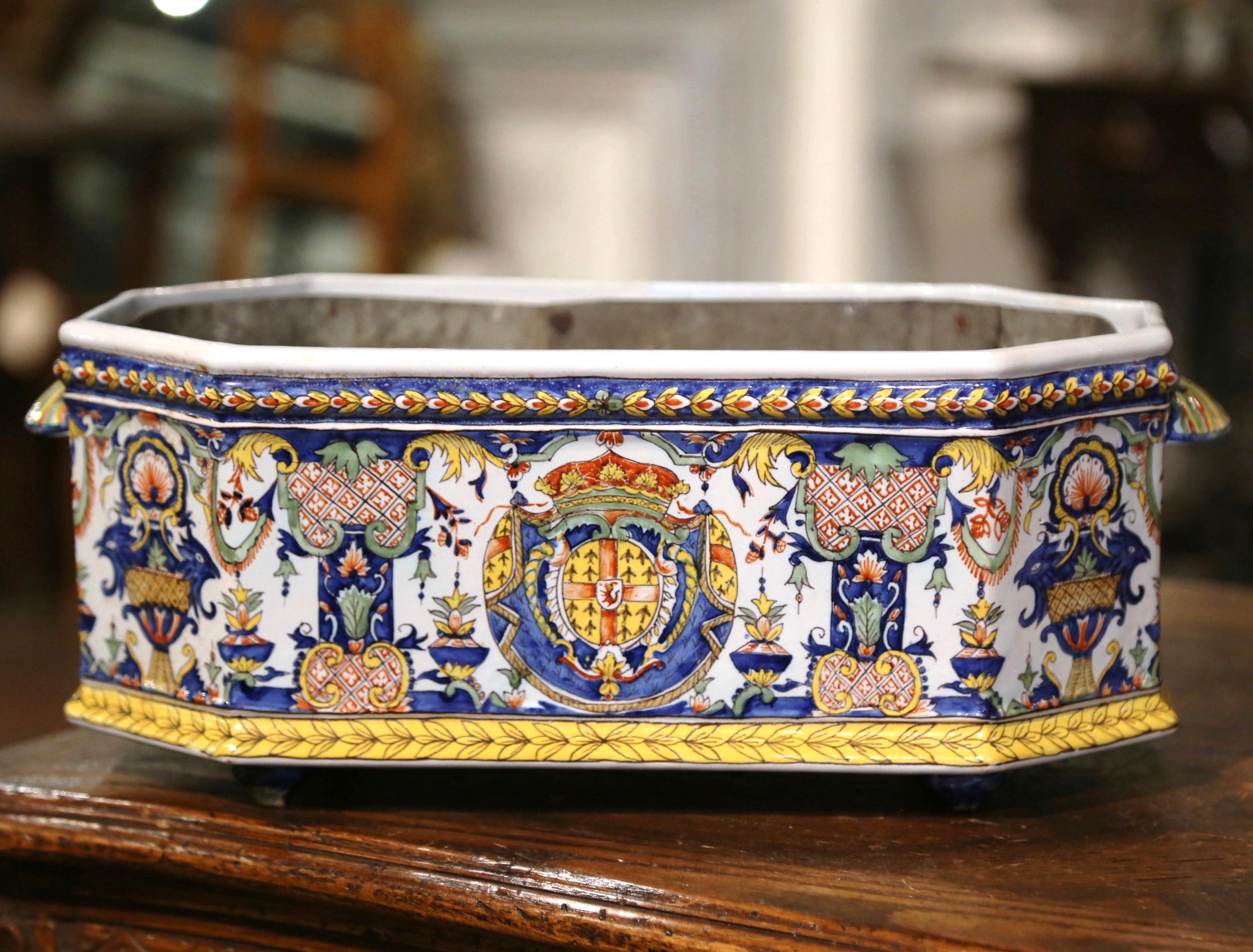 Decorate a mantle, table or buffet with this colorful antique jardiniere with original inside tole liner. Sculpted in Normandy France circa 1880, and octagonal in shape, the ceramic planter is dressed with two small shell-form handles, and is