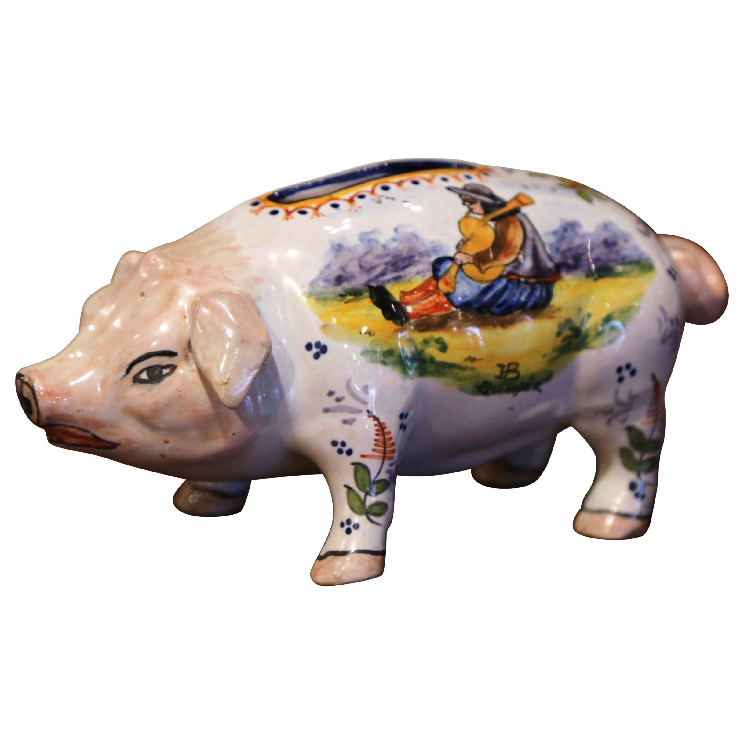 Complete your faience collection with this colorful antique piggy bank from Brittany. Crafted in Quimper, France, circa 1890, the ceramic piece depicts a standing and sniffing pig sculpture with open slot on the top. The coin keeper is decorated