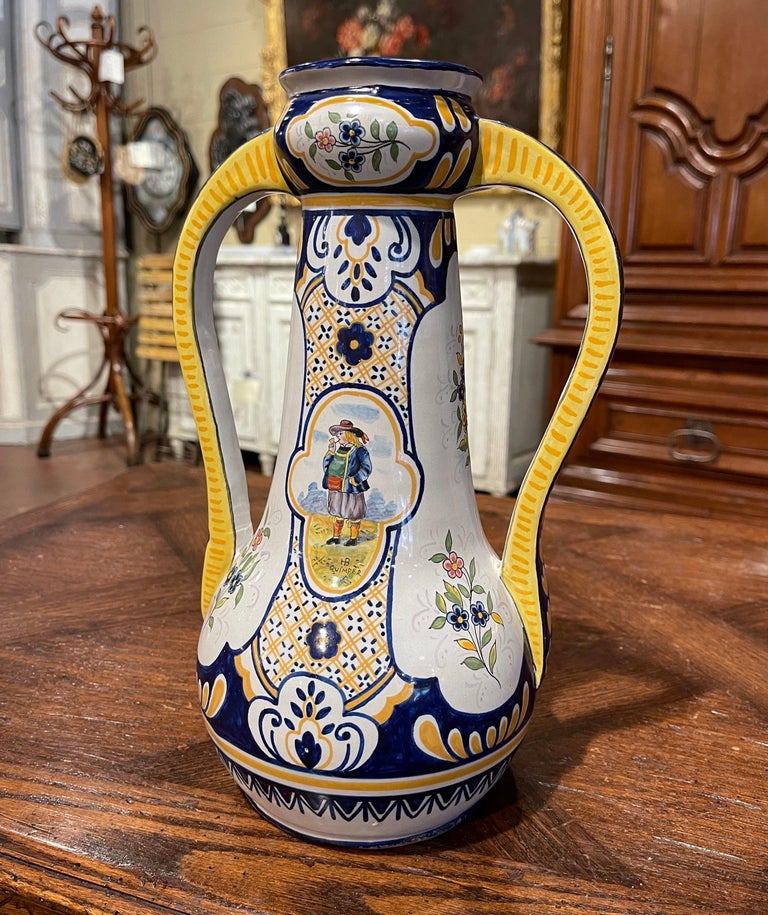 Complete your faience collection with this colorful antique vase from Brittany. Crafted in Quimper, France, circa 1880, the jar is round in shape and dressed with two scrolled handles over the long neck. The vessel features hand painted motifs with