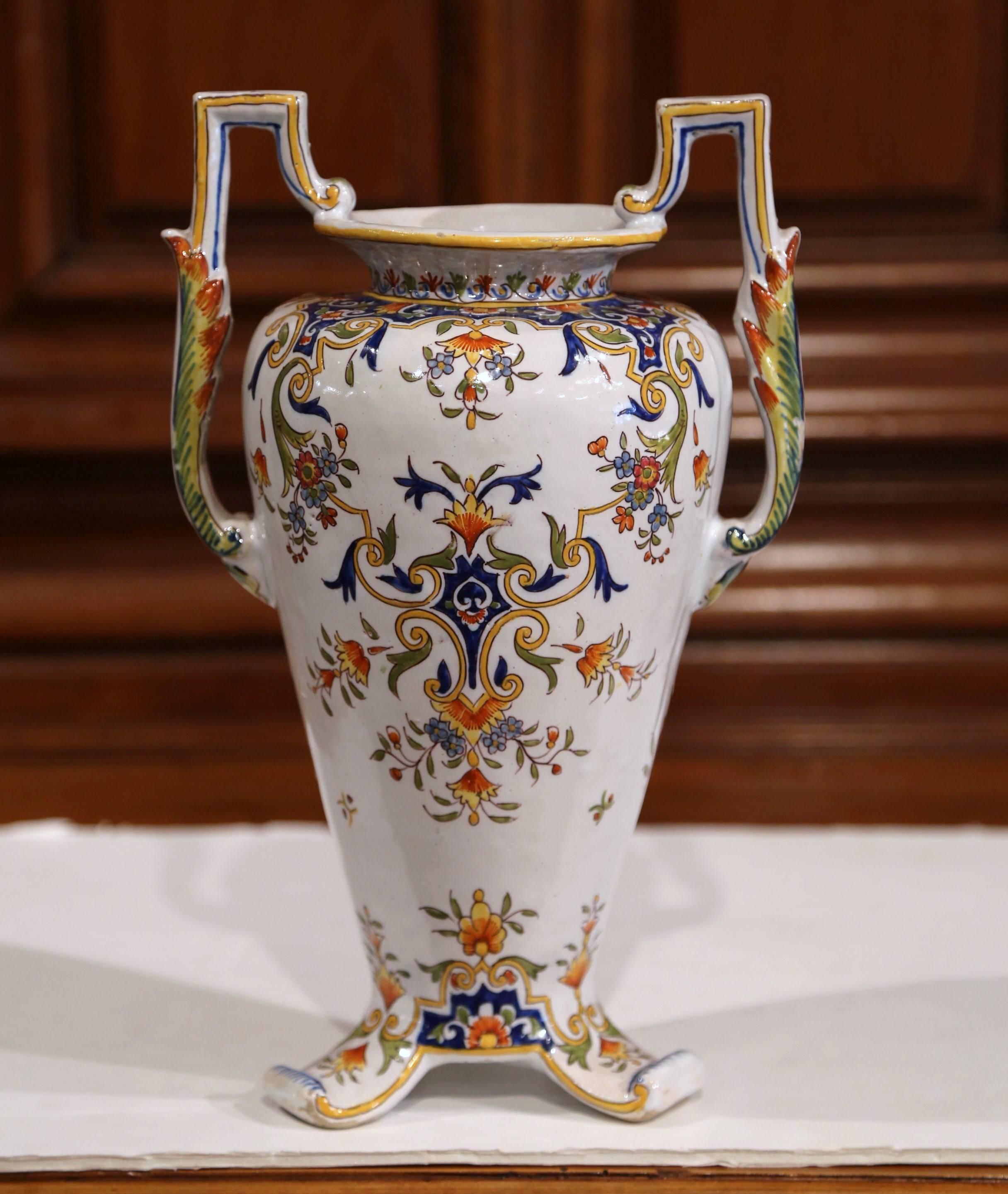 Make a statement of beauty with this elegant, antique vase. Crafted in Normandy, France, circa 1870, the vase is a true piece of art with a sculptural shape and details. Sited on three small feet, the colorful flower vase has artful handles on each