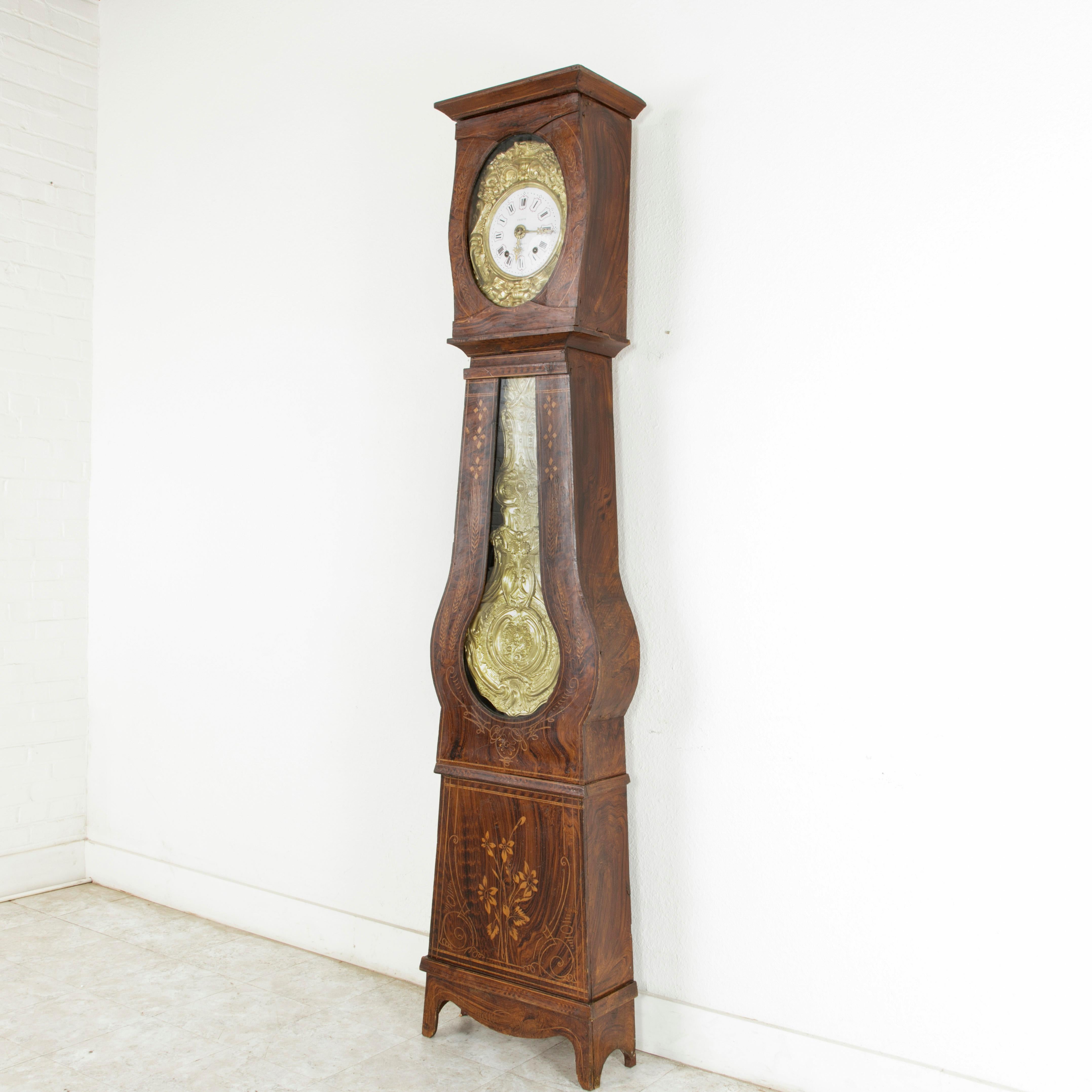 This mid-19th century French pine grandfather clock features a case of hand painted faux bois that resembles burl walnut. Painted detailing of flowers and shocks of wheat adorn the facade. This attention to detail is also evident in the back of the