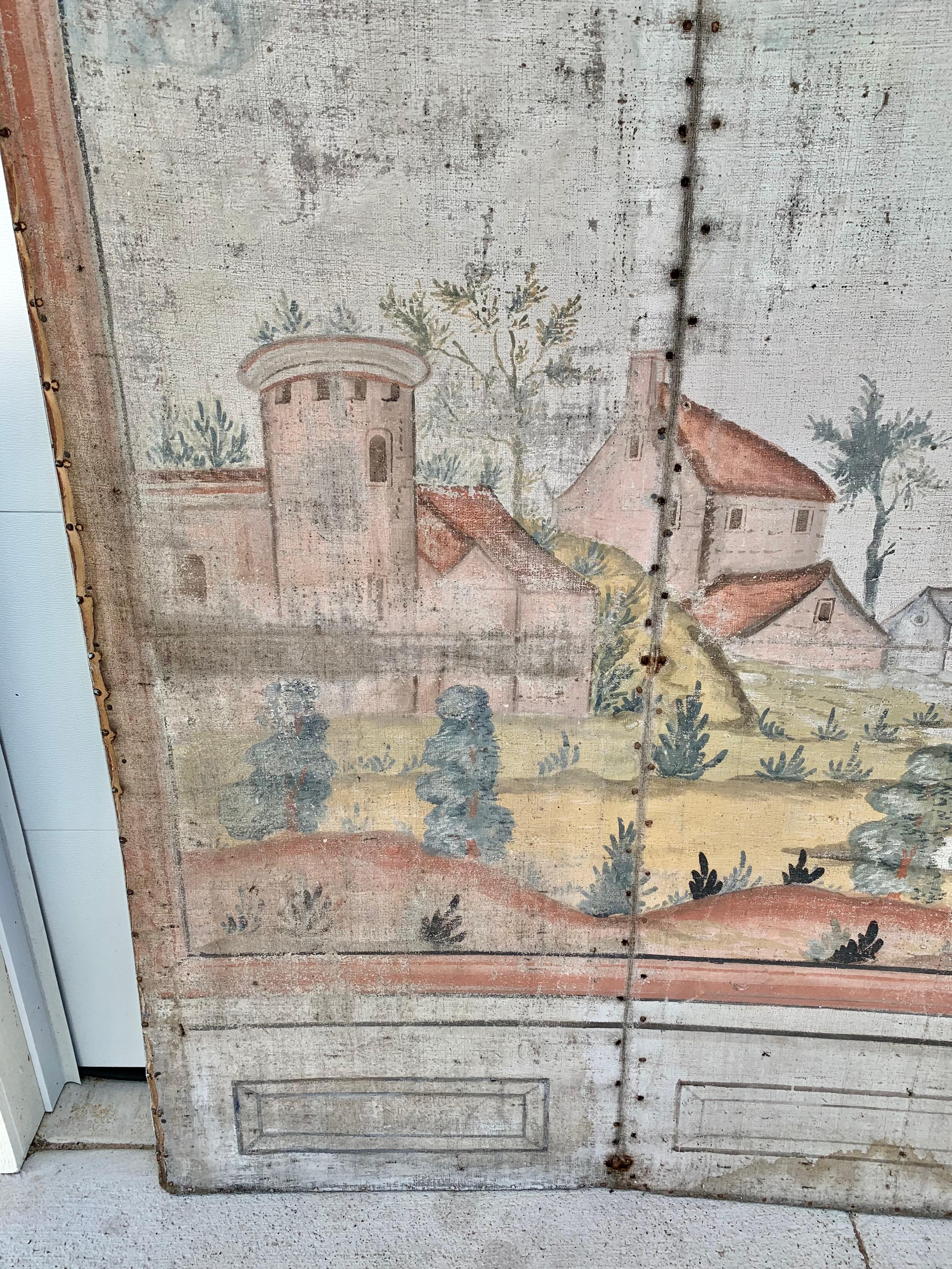 Found in the South of France, this 19th Century French Four Panel Folding Screen was hand painted by artisans in the 1800's. The piece features four arched intricately painted panels depicting a French Provincial landscape to include architecture,