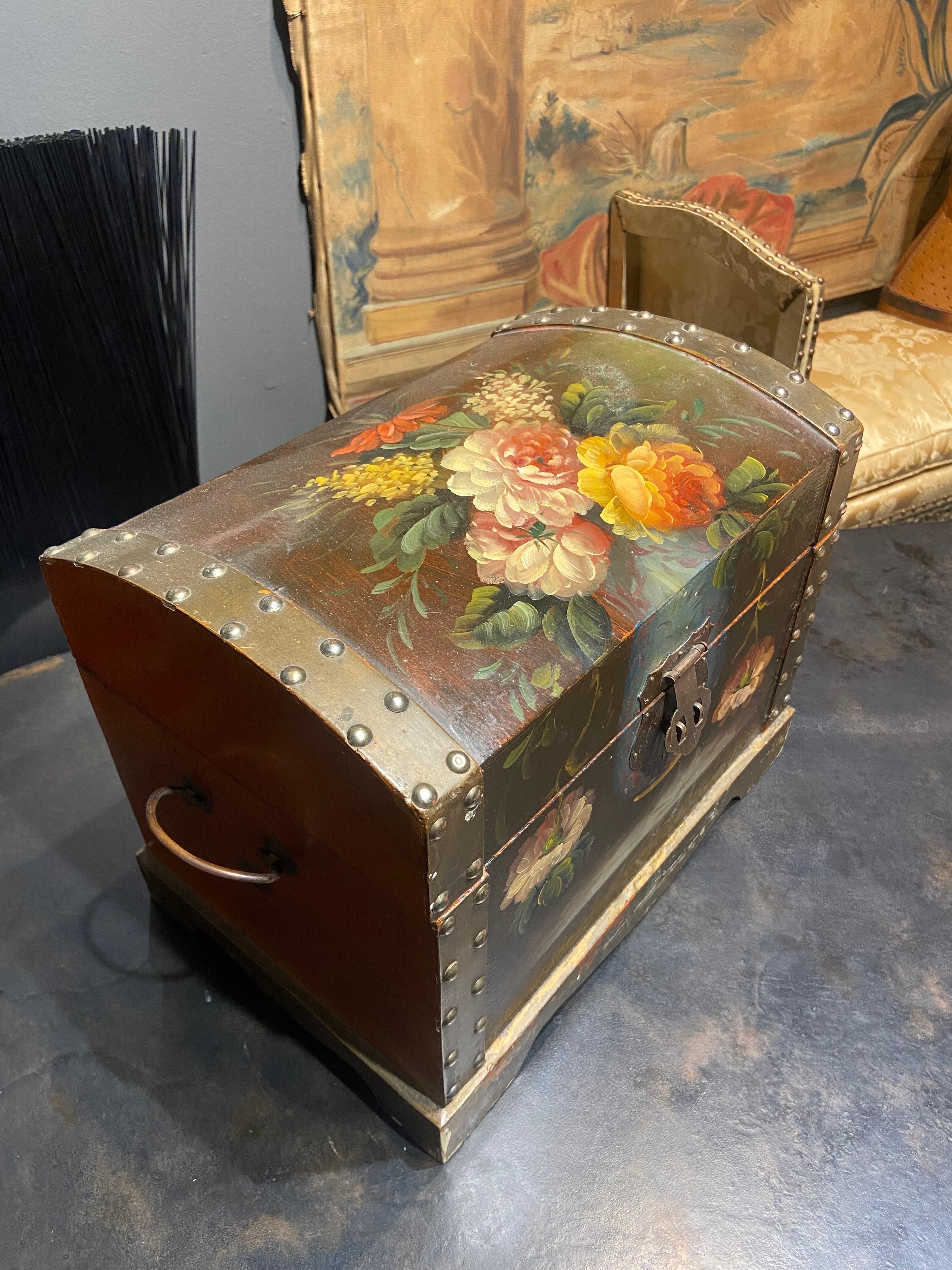 Beautiful hand painted wooden box decorated in very romantic style with lovely flowers on the top and front side. The edges of the box are made of metal and there are metal handles at the sides. The inside of the piece is painted in black. 
France,