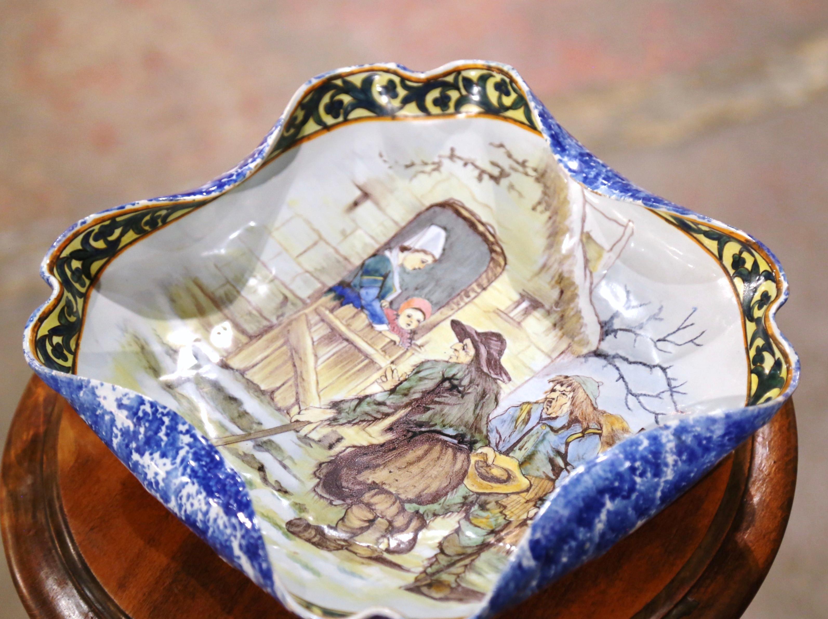 Decorate a table or a shelf with this large antique dish from Porquier Beau. Created in Quimper Brittany, France circa 1895, the colorful hand painted ceramic dish is almost square in share and embellished with scalloped and curved edges. The tray