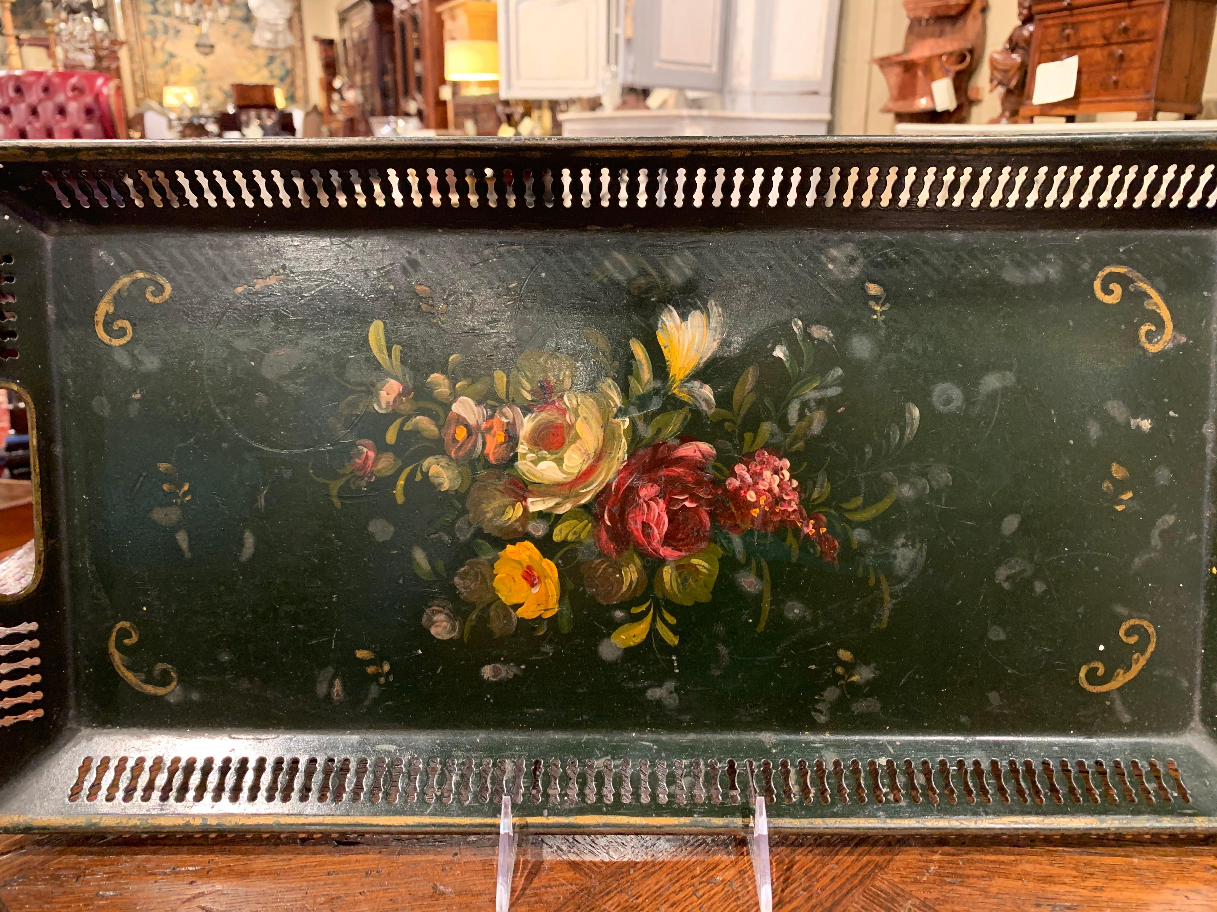 This elegant antique gallery tray was crafted in Normandy, France, circa 1870; rectangular in shape, the colorful tray features a pierced gallery with two handles around the perimeter and is decorated by hand painted flowers and leaf motifs in the