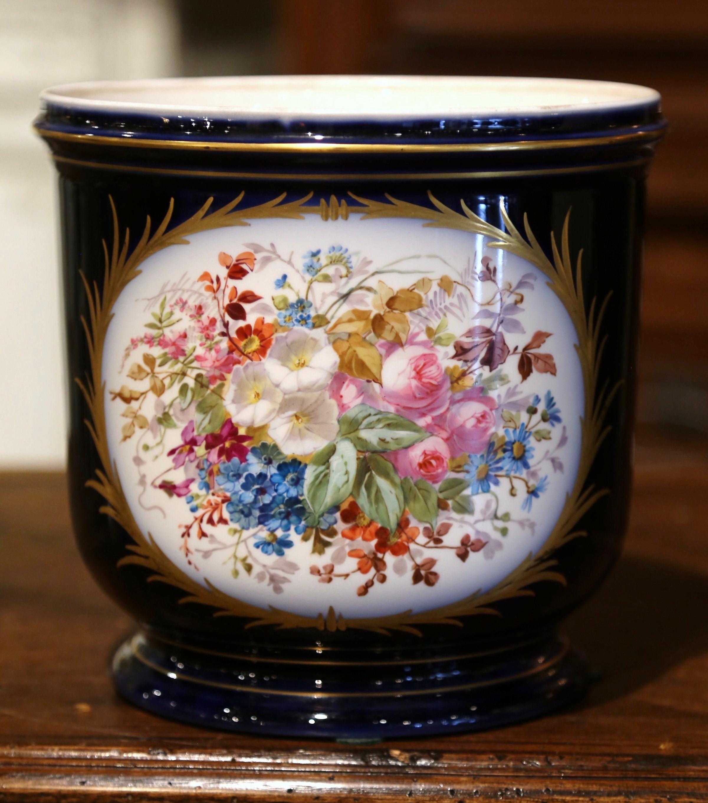 Decorate a table or a buffet with this elegant antique jardiniere. Crafted in Paris, France circa 1880, the porcelain cache pot is decorated with two medallions; one depicting a courting scene with two lovers, and the other with a large flower