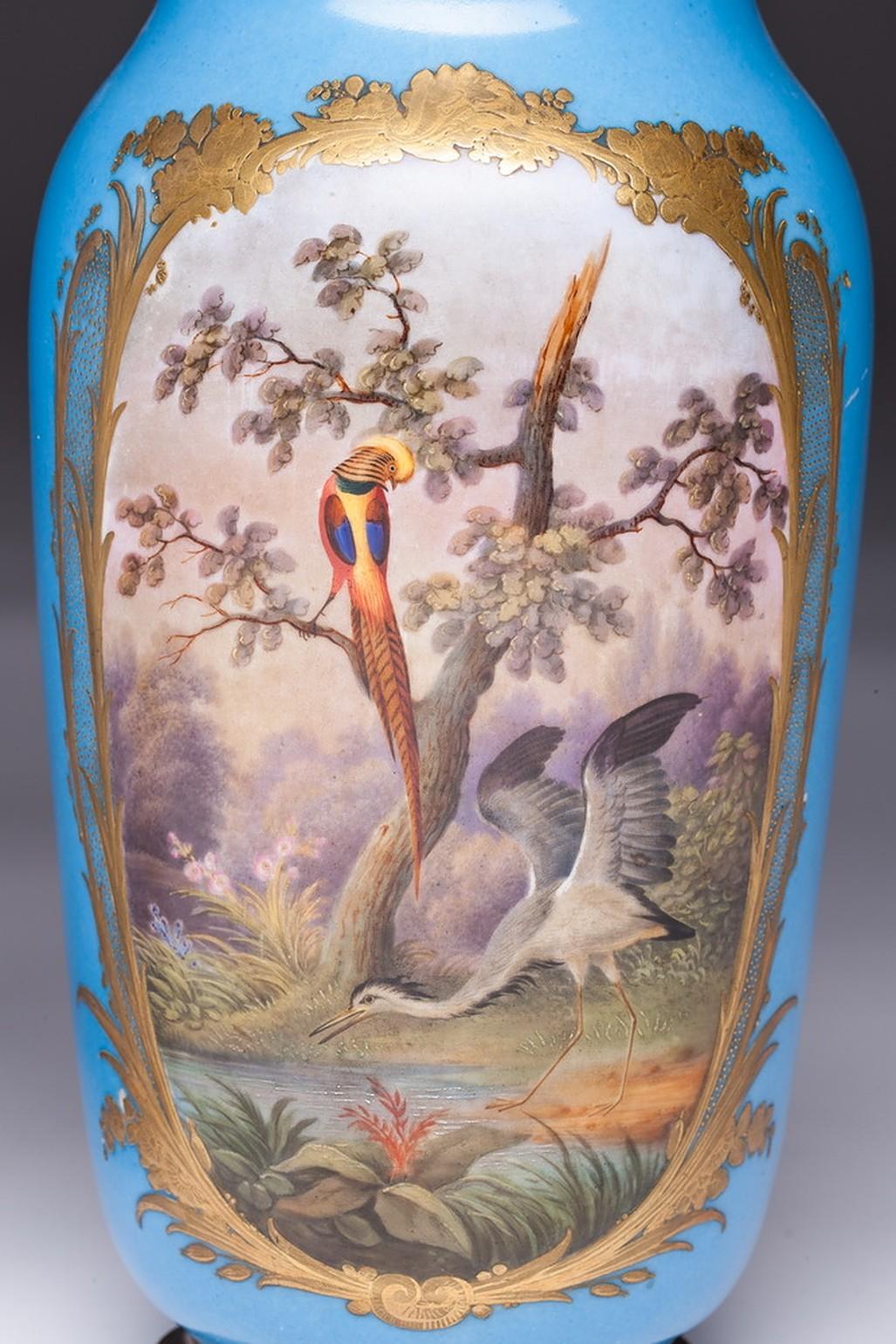 19th century light blue background vases. This color is also named Turquoise color. One side of vases is with a gold-framed cartouche with lattice decor and flower tendrils, polychrome painted landscape with tree and birds. Other side of the vases