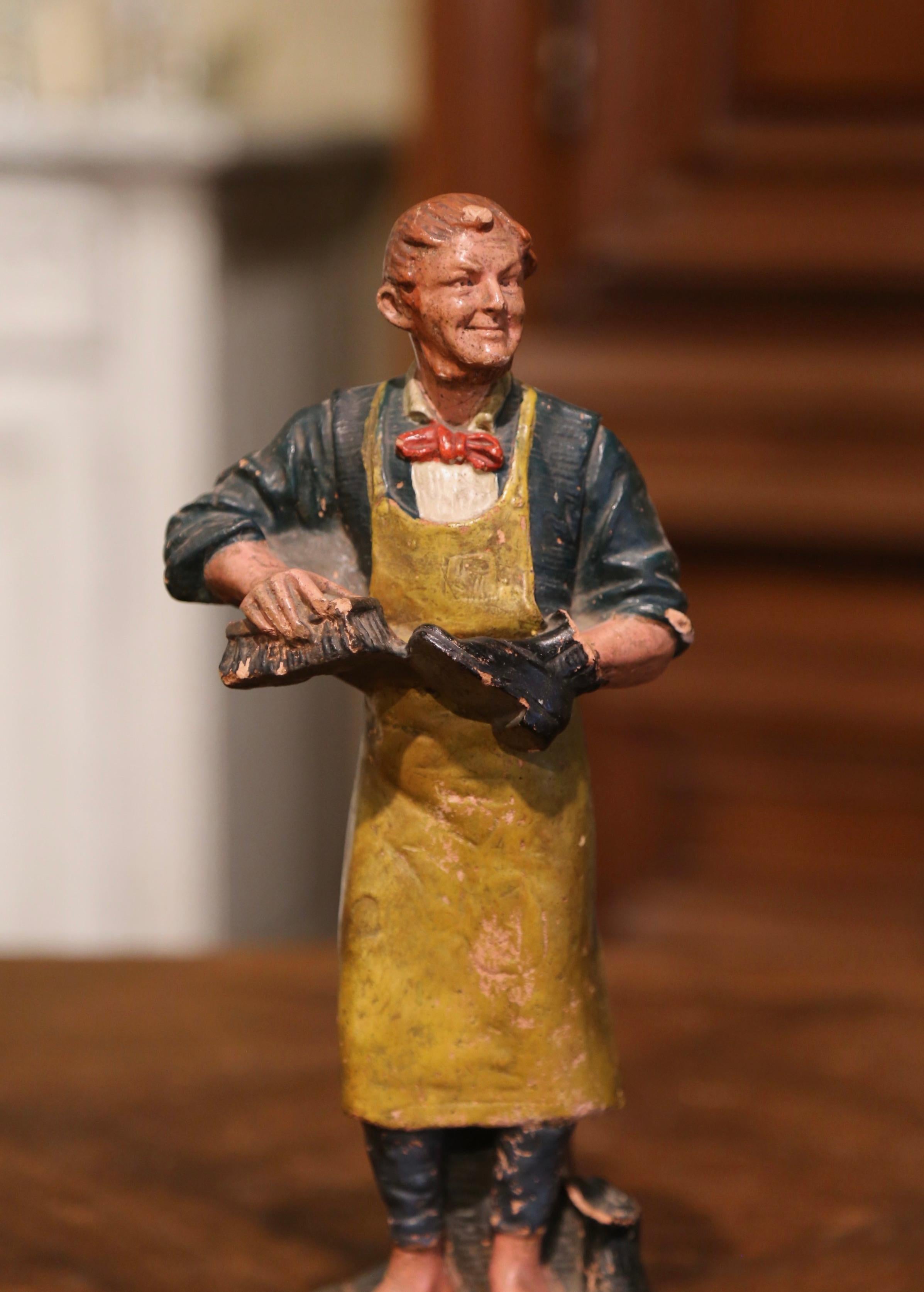 Place this colorful antique figurine on a shelf or convert it into a table lamp; crafted in France, circa 1880, the terracotta figure depicts a man in 19th century clothing, cobbling shoes. It's an endearing piece which captures the charm of French
