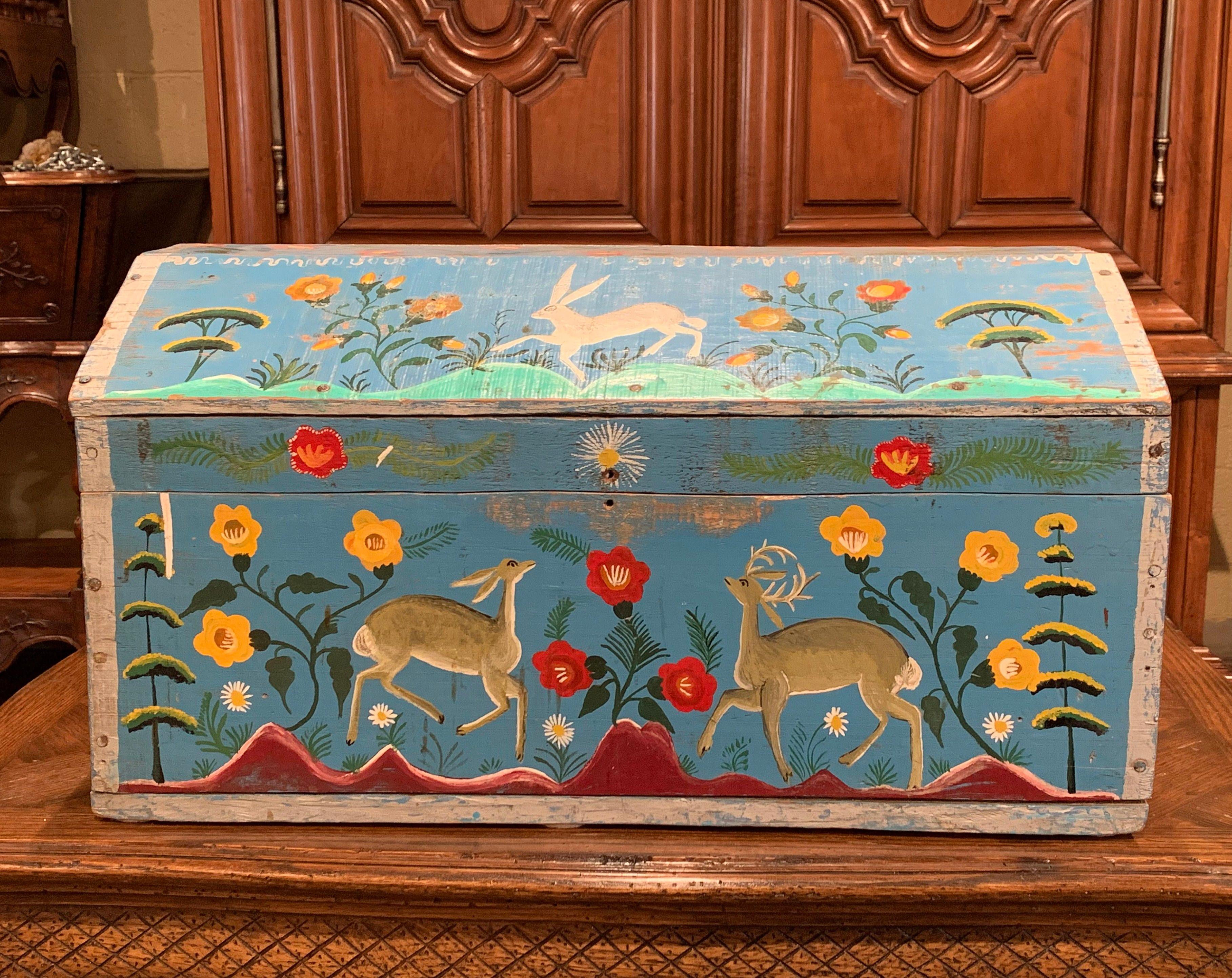 This beautifully executed antique wedding trunk was crafted in northern France, circa 1880. The colorful bombe box features hand painted decorations in a vibrant blue, green and red palette. The traditional trunk is decorated with rabbits and deer