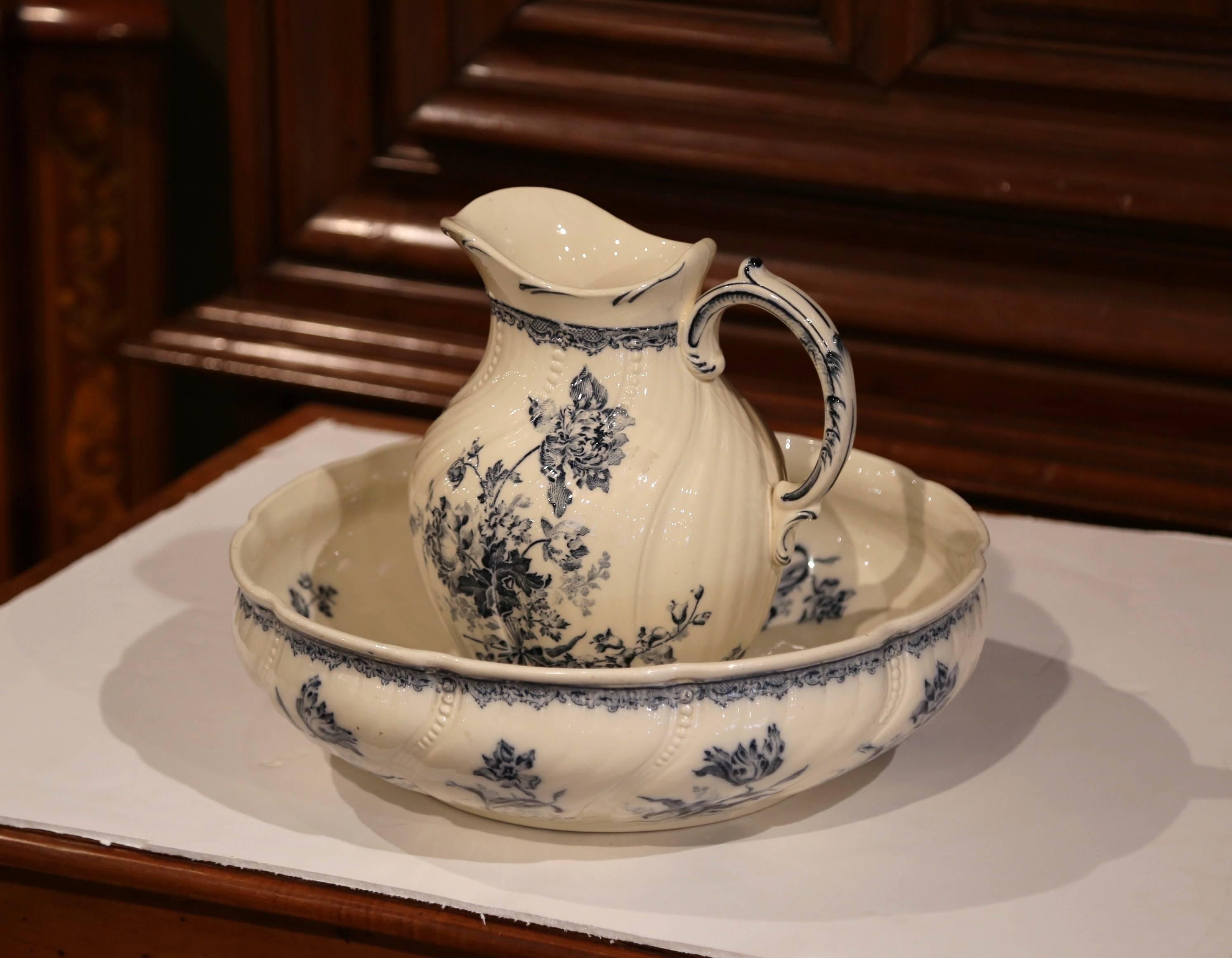 This elegant antique water pitcher with matching bowl was crafted in Sarreguemines (Lorraine), France, circa 1860, the hand painted ceramic set with blue and white flowers was typically used to freshen up in the morning. Good condition overall with