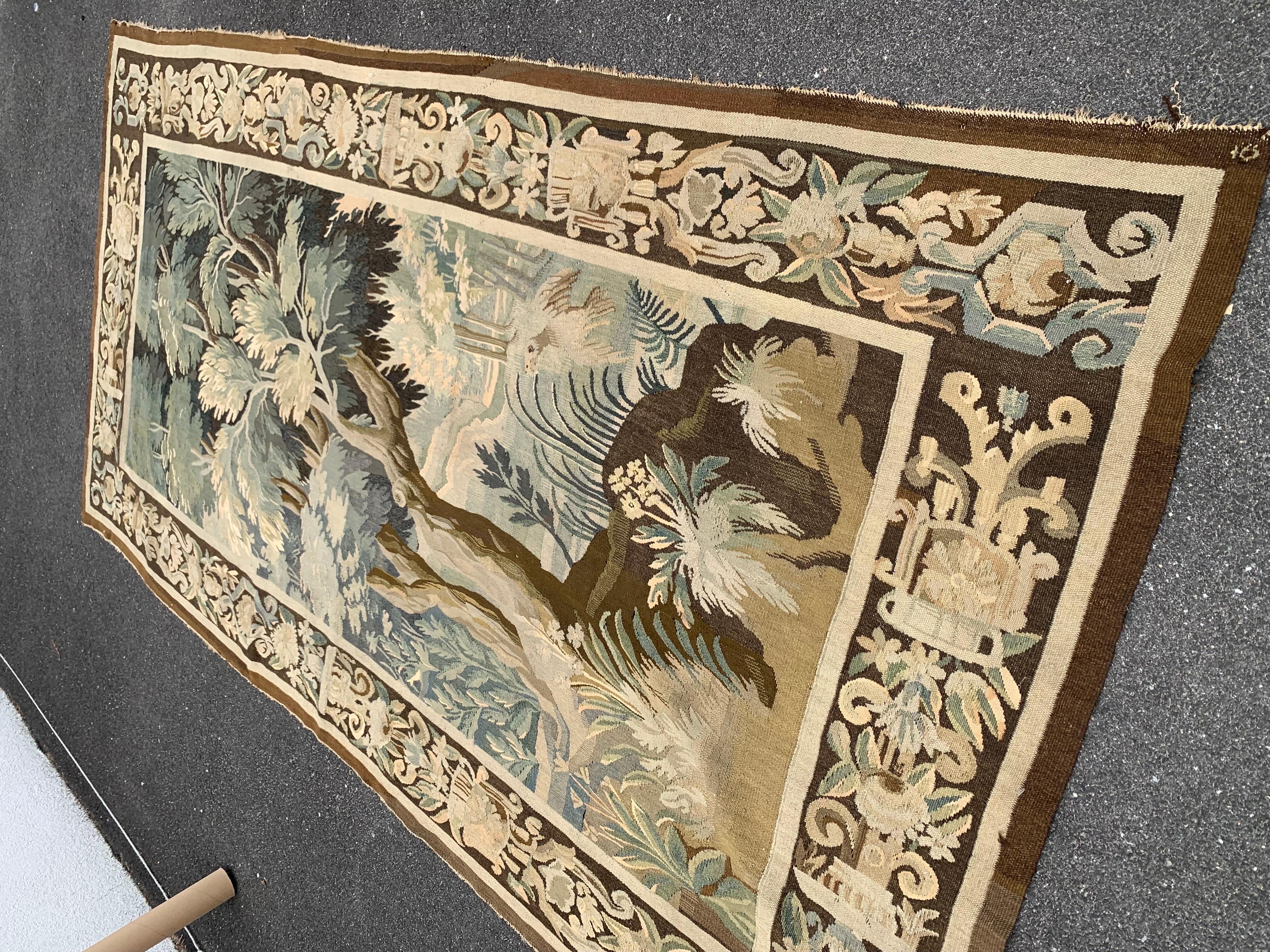Place this long and narrow antique tapestry in a staircase or in between two windows for a pop of color. Handwoven in Aubusson, France, circa 1860, this gorgeous verdure wall piece has its original fruit and floral border. It measures 10.3 x 5.3 ft.