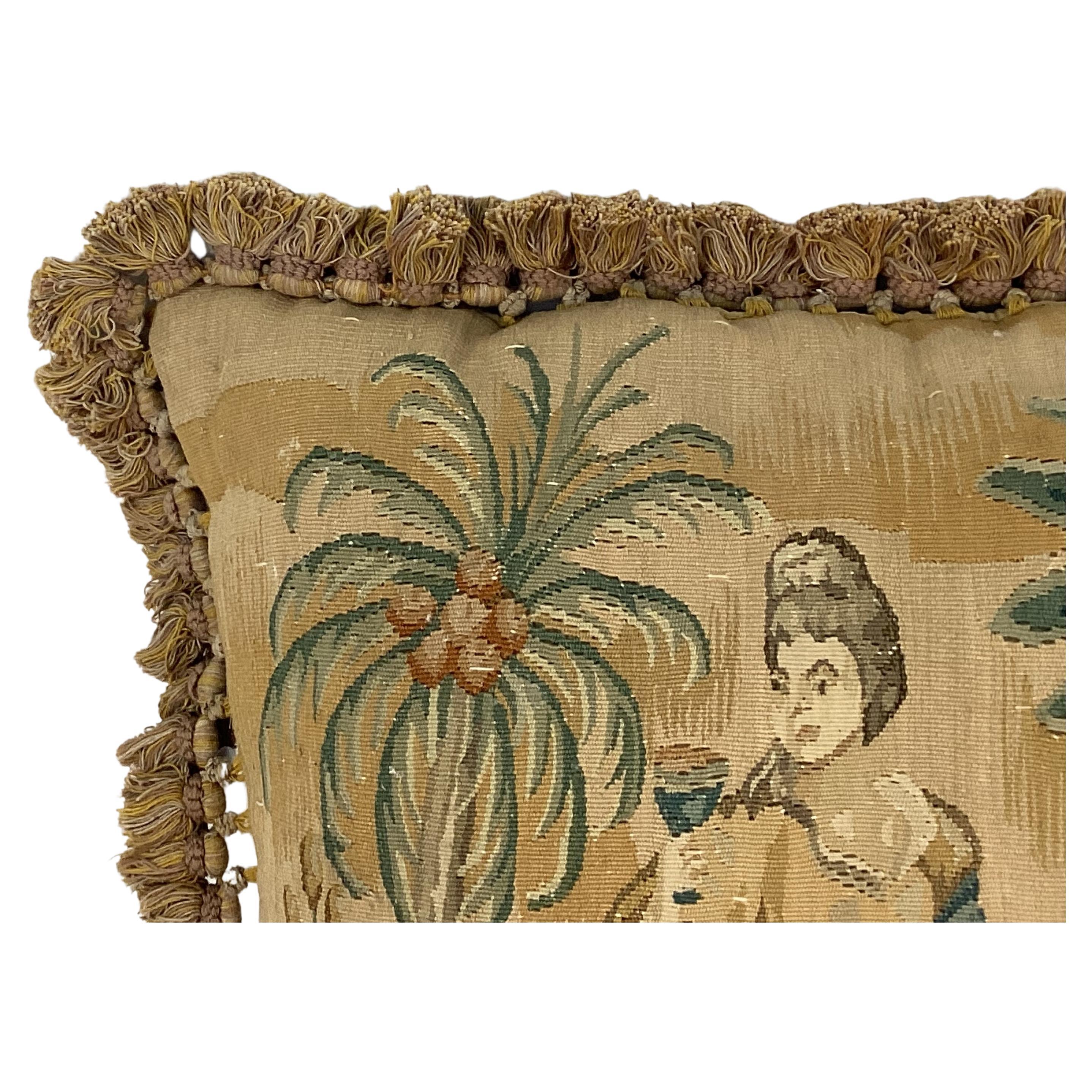 19th Century French custom made Hand-Woven Tapestry with pillow insert (included).  Tapestry features a beautiful outdoor setting of a woman eating fruit under palm trees in soft tan, green and brown colors. Backing is newer cotton velvet and border
