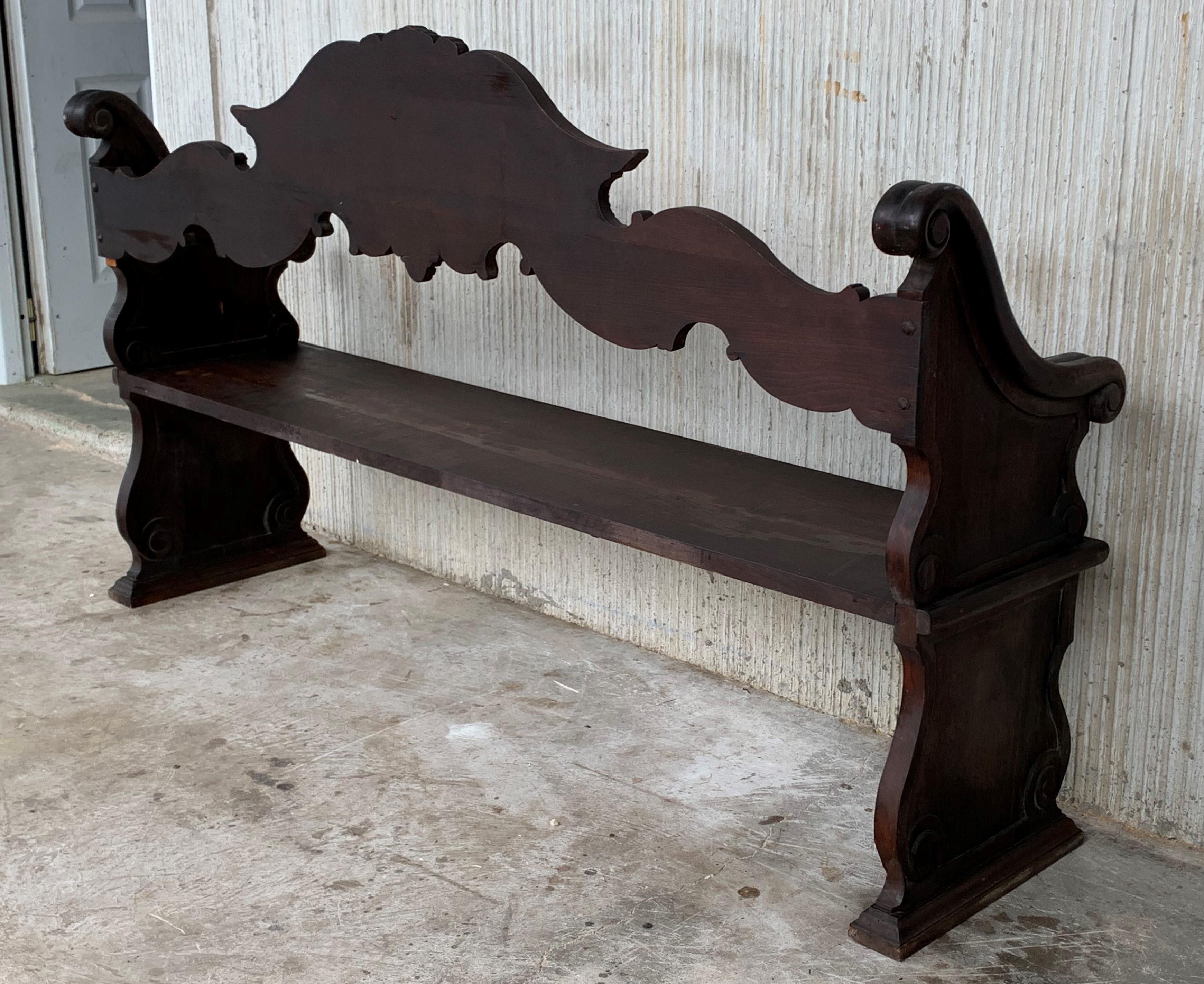 19th century French bench made from oak. The back is exquisitely hand carved with two differents motifs, surrounded by decorative carvings. The sides are made up of matching decorative pierced carvings. The seat has a beveled front edge, and the