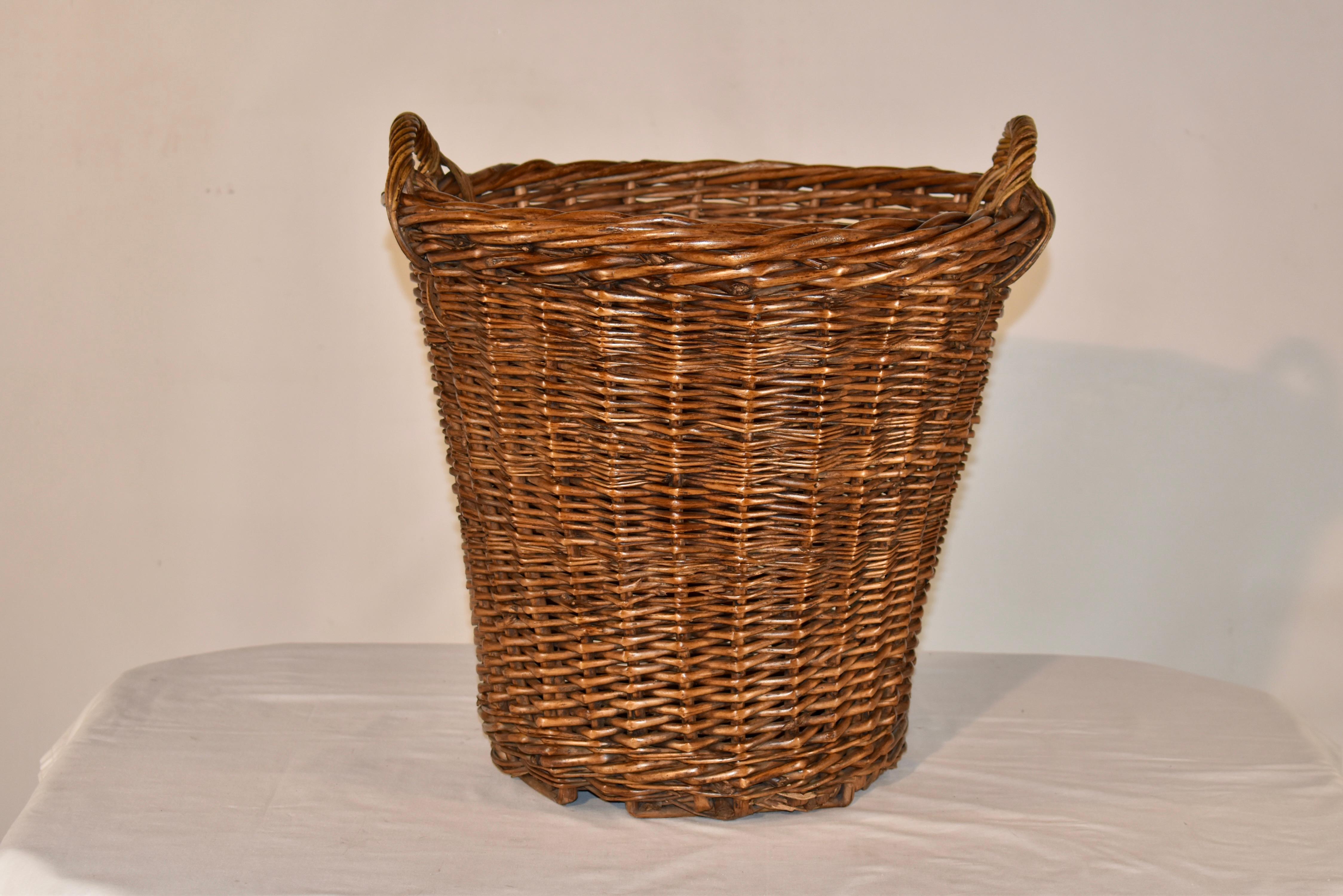 19th century wicker basket from France.  The handles are handy for lifting.  This basket would be great for use as a hamper, organize toys,  or in any room of the house where you need some additional organization!