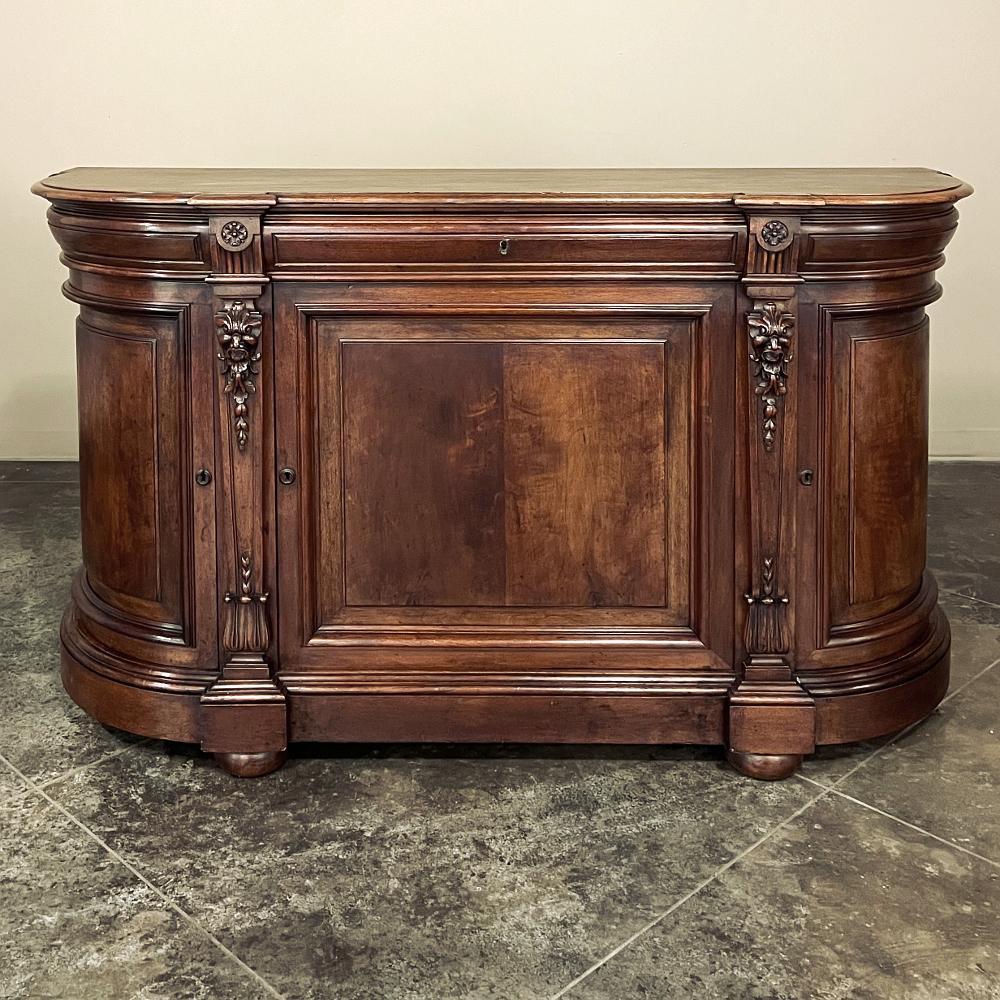 19th Century French Henri II walnut buffet is a fine example of the revival of neoclassical style during the reign of Napoleon III. Utilizing sumptuous, hand-select French walnut, the artisans skillfully created a round-sided casework with slight