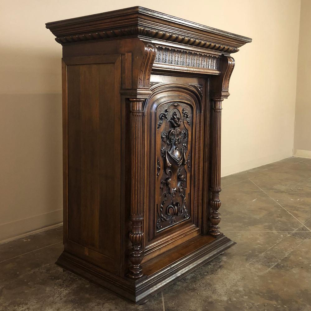 19th century French Henri II walnut confiturier ~ Cabinet is a splendid example of fine craftsmanship and wood sculpture, with neoclassical architecture melded with stylized naturalistic form! The bold full relief carvings on the door panel capture