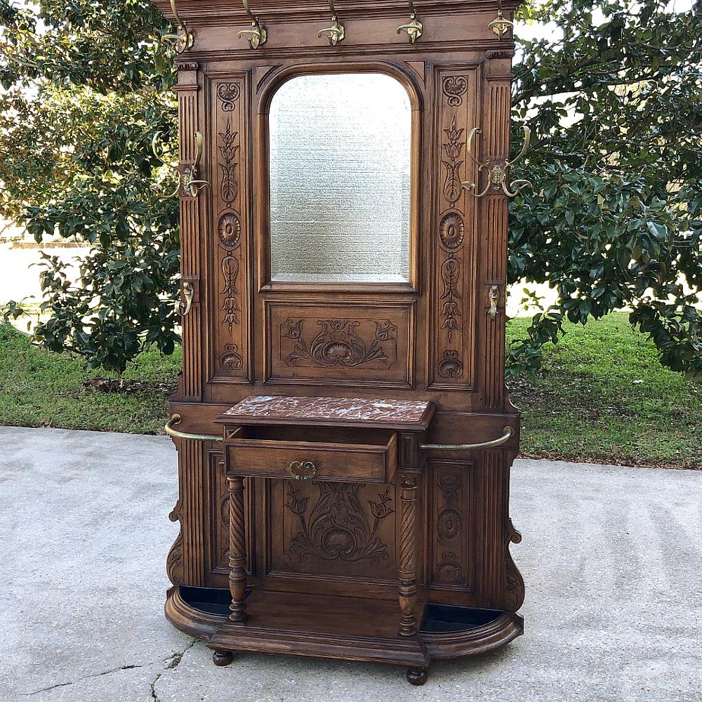 19th century French Henri II walnut hall tree is the perfect piece to serve next to your doo to greet all who enter with a place to hang one's hat, coat or sweater, park the umbrella, even take off wet gloves and empty keys out of pockets! The