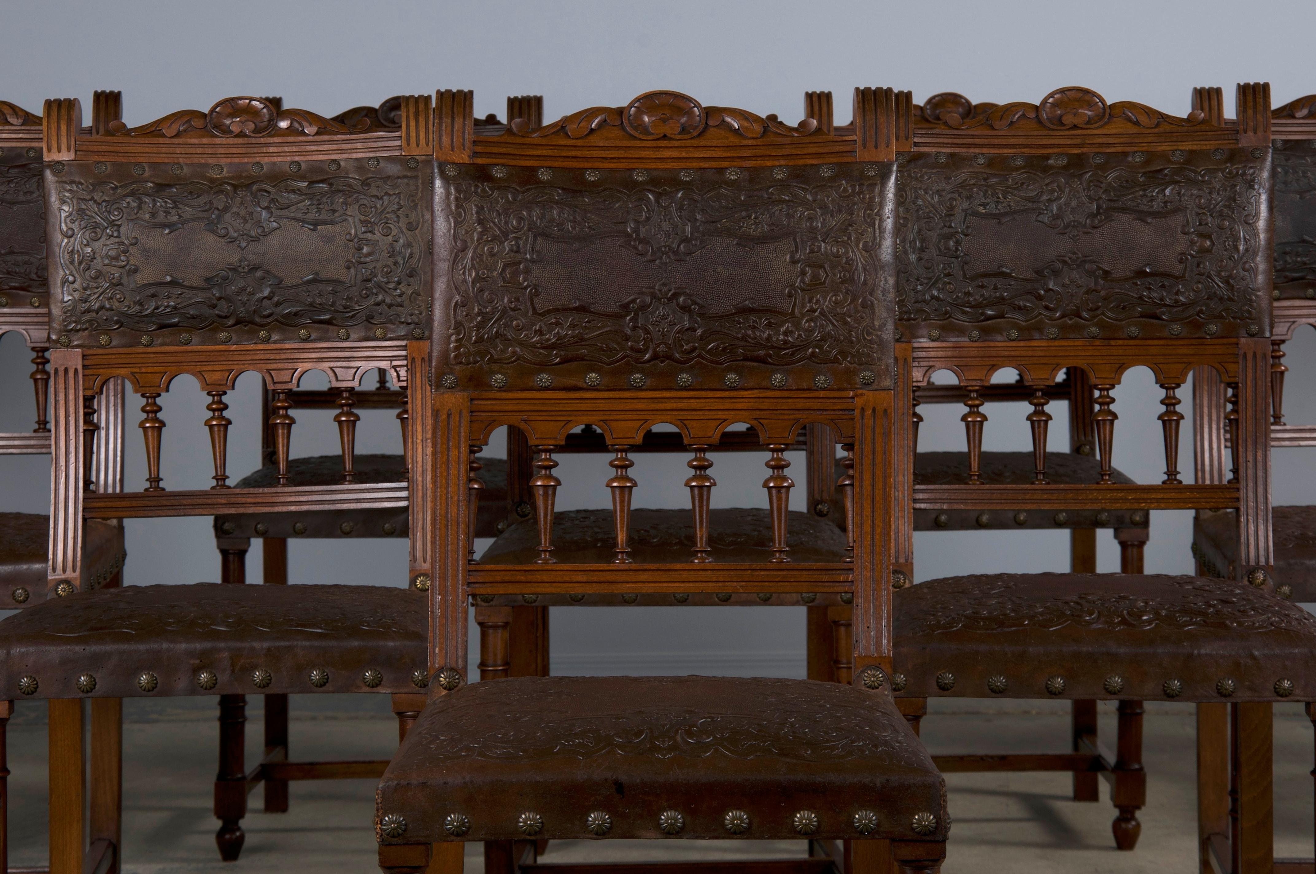 A grand set of ten late 19th-century French dining chairs made in the style of Henry II, sourced from Provence, France. Beautifully hand-crafted from solid walnut wood featuring elaborately carved frames with intact spindles and finials. The wood