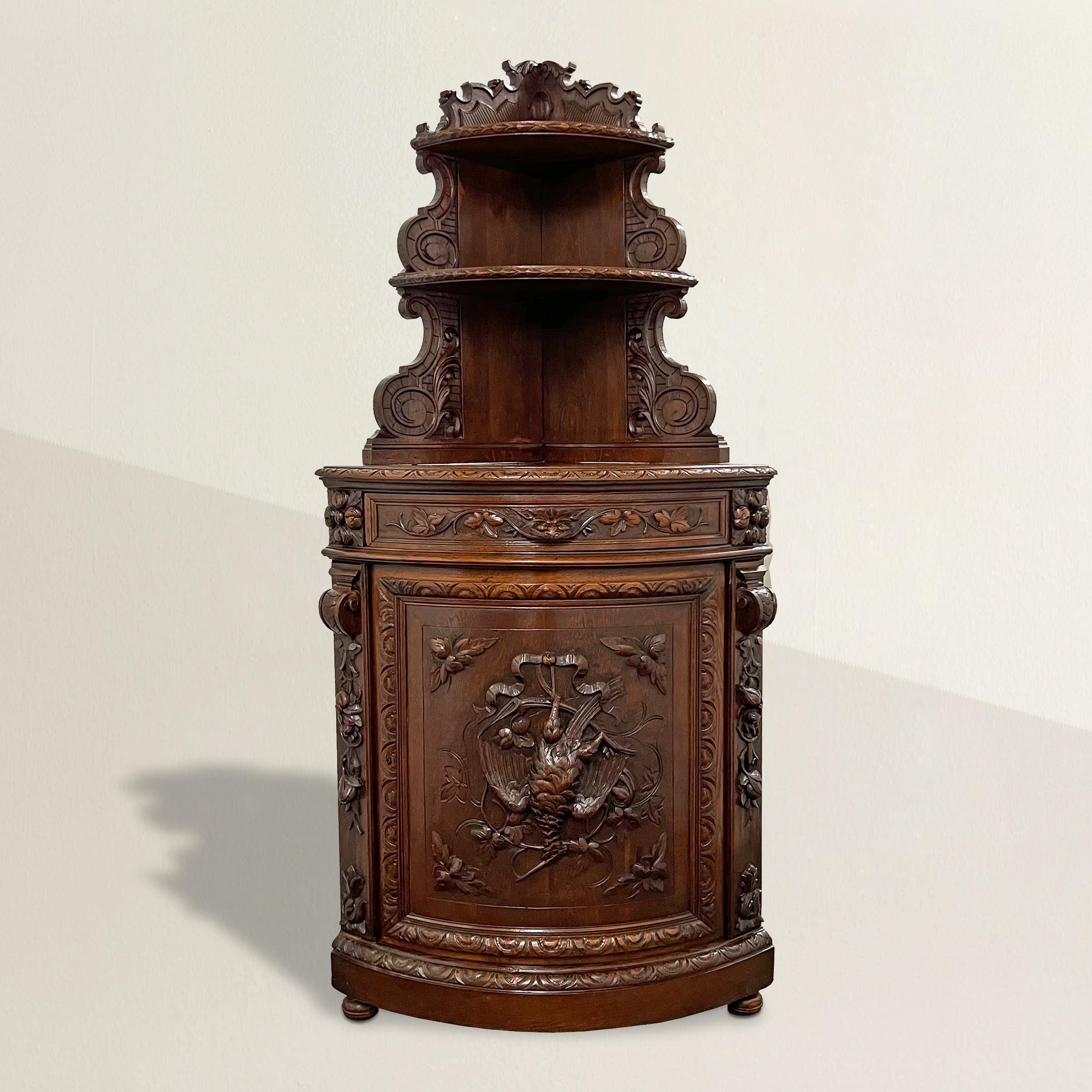Immerse yourself in the charm of the late 19th century with this exquisite French Renaissance Revival hunt-themed corner cabinet from a hunting lodge. Adorned with intricate, ornate carvings featuring delicate floral and luscious fruit motifs, this