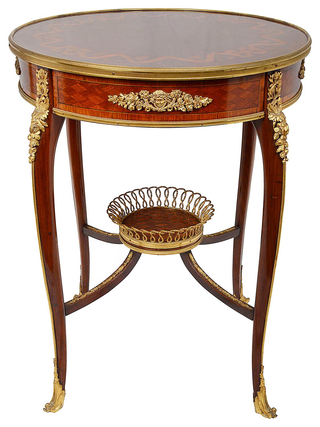 A very good quality French gueridon, having wonderful inlaid parquetry, ribbon and bow decoration to the top, gilded ormolu mounts to the frieze, legs and under-tier, raised on elegant cabriole legs.
In the style of Francoise Linke.