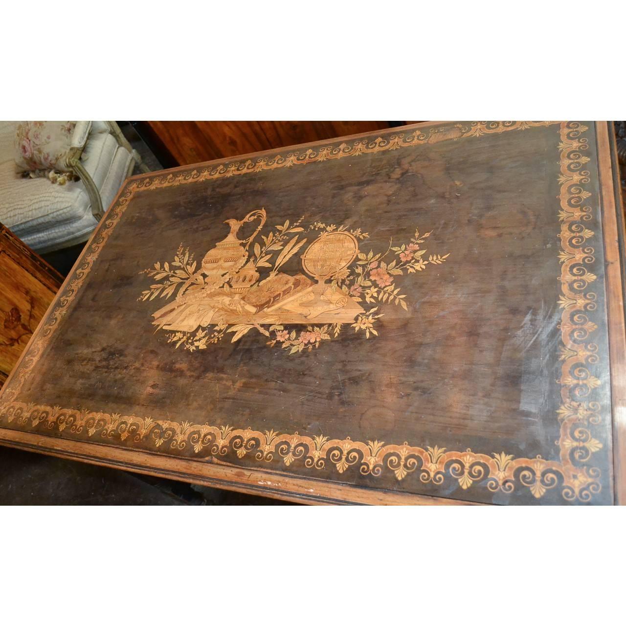 Exceptional 19th century French walnut writing table or desk. The top with outstanding exotic wood marquetry inlays depicting an urn, inkwell, a book, world globe, and parchment amidst colorful leaf and floral sprays. The border with additional