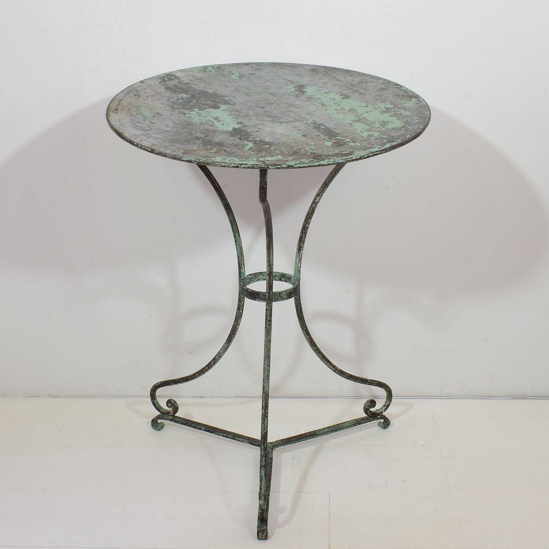 Great iron bistro table with a beautiful weathered look.
France, circa 1850-1900
Weathered.
 
