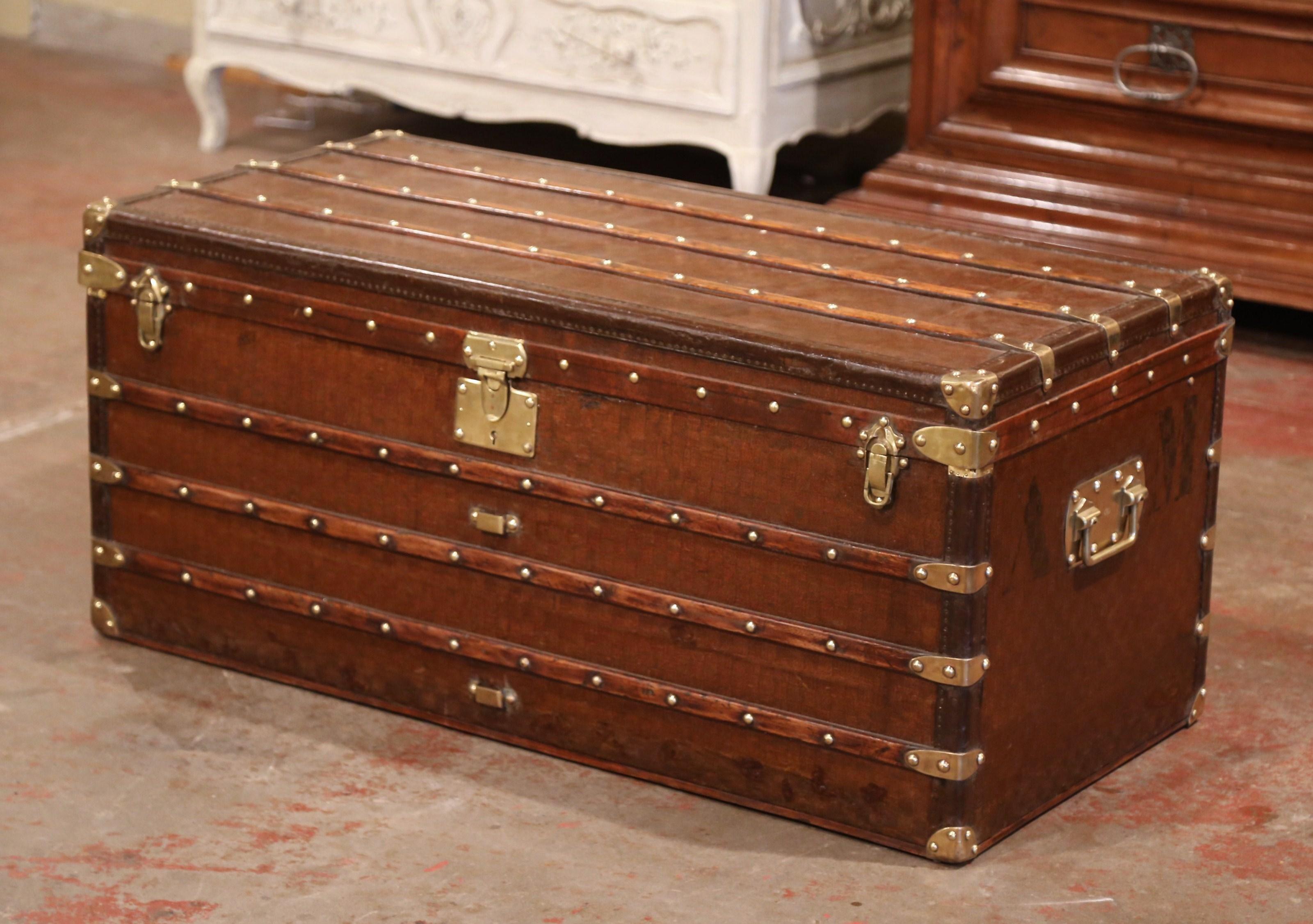 This large trunk would make an elegant coffee or cocktail table! Crafted in Paris circa 1880, the antique trunk is rectangular in shape, and finished on all four sides including the top, it features heavy brass handles with engraving stamp of