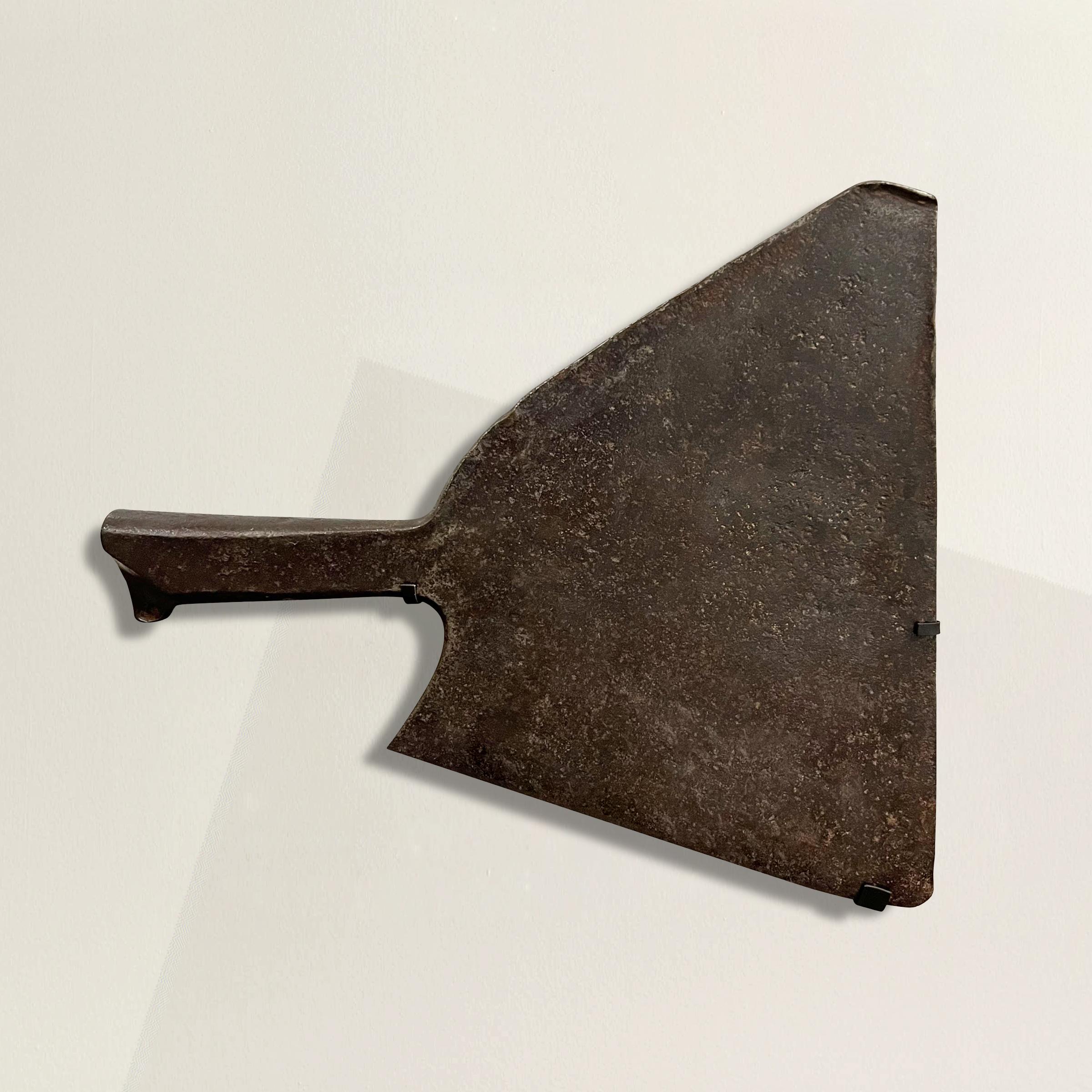 Unleash a slice of culinary history with this 19th-century French iron butcher's cleaver, a robust masterpiece echoing the craftsmanship of a bygone era. The large triangle-shaped blade and seamlessly integrated handle, forged from a single piece of