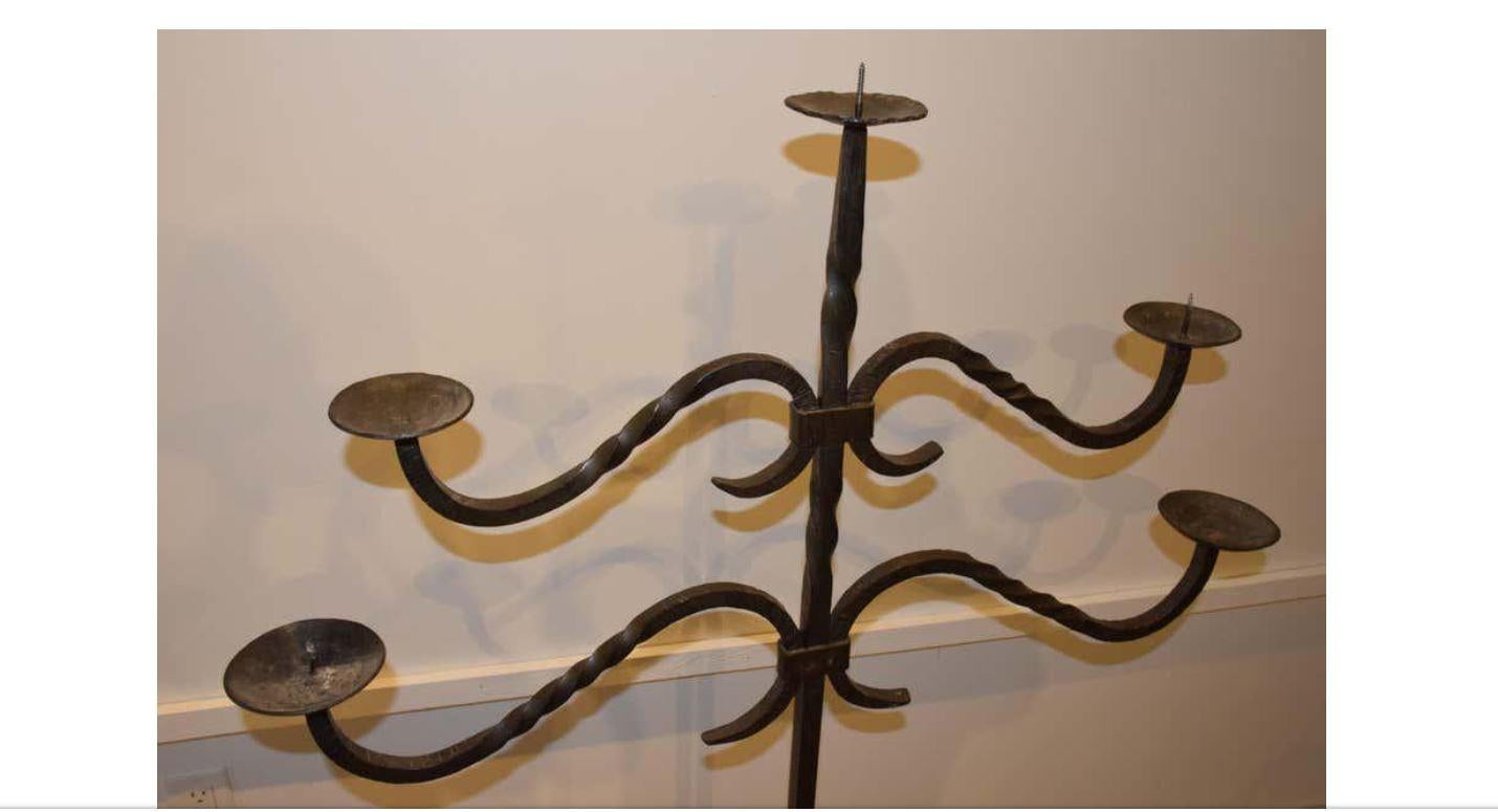 Found in the South of France, this hand forged iron floor Candelabra with five arms depicts unique craftsmanship. Although two of the spikes are missing, this Candelabra will hold up to a 2.5 inch pillar candle on each arm. This would make a great