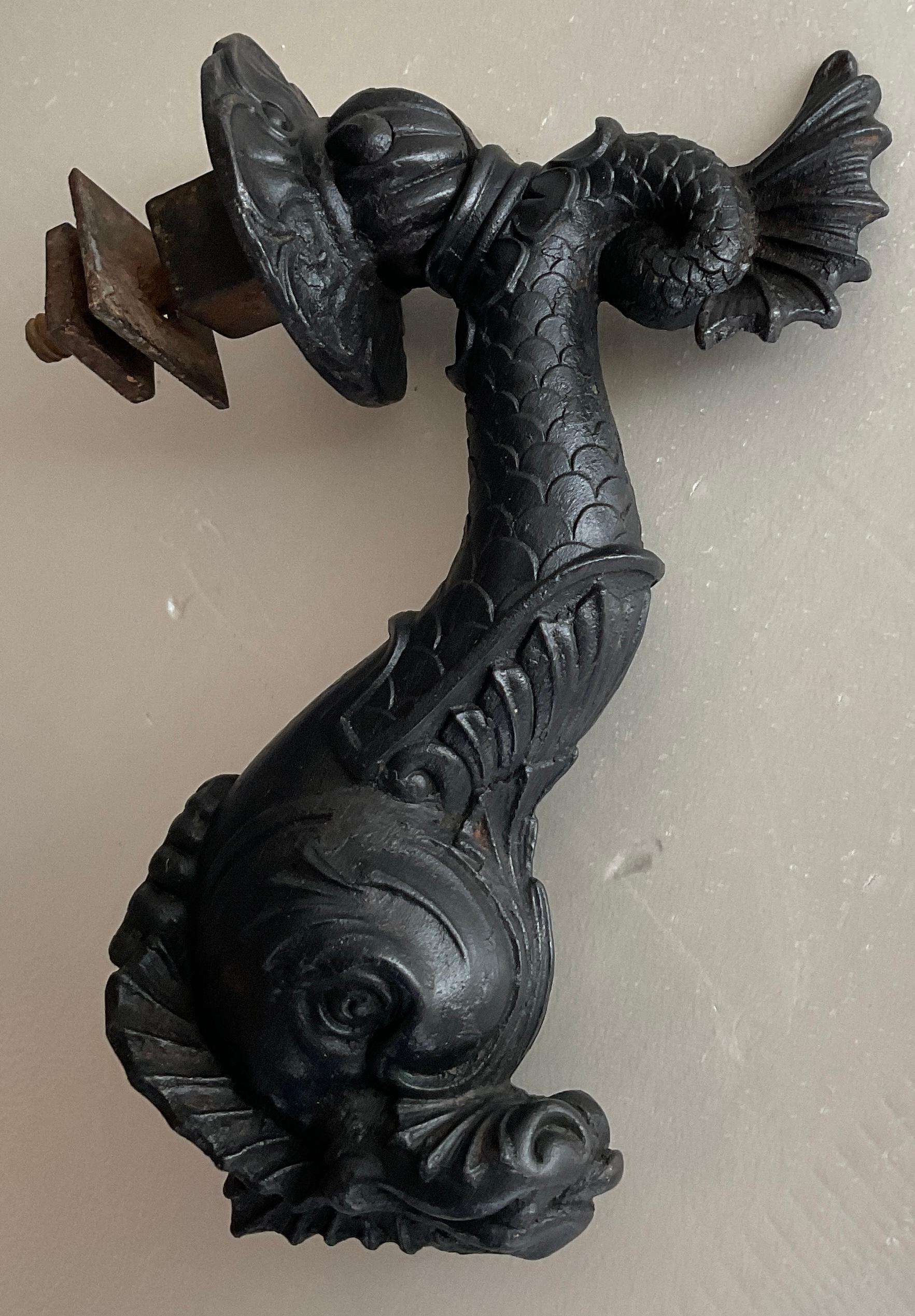 A fine quality French cast iron door knocker. The figure is a mythological dolphin with a fan shaped tail.

This original 19th Century door knocker will enhance any entrance door and will delight viewers.

Measures: 8