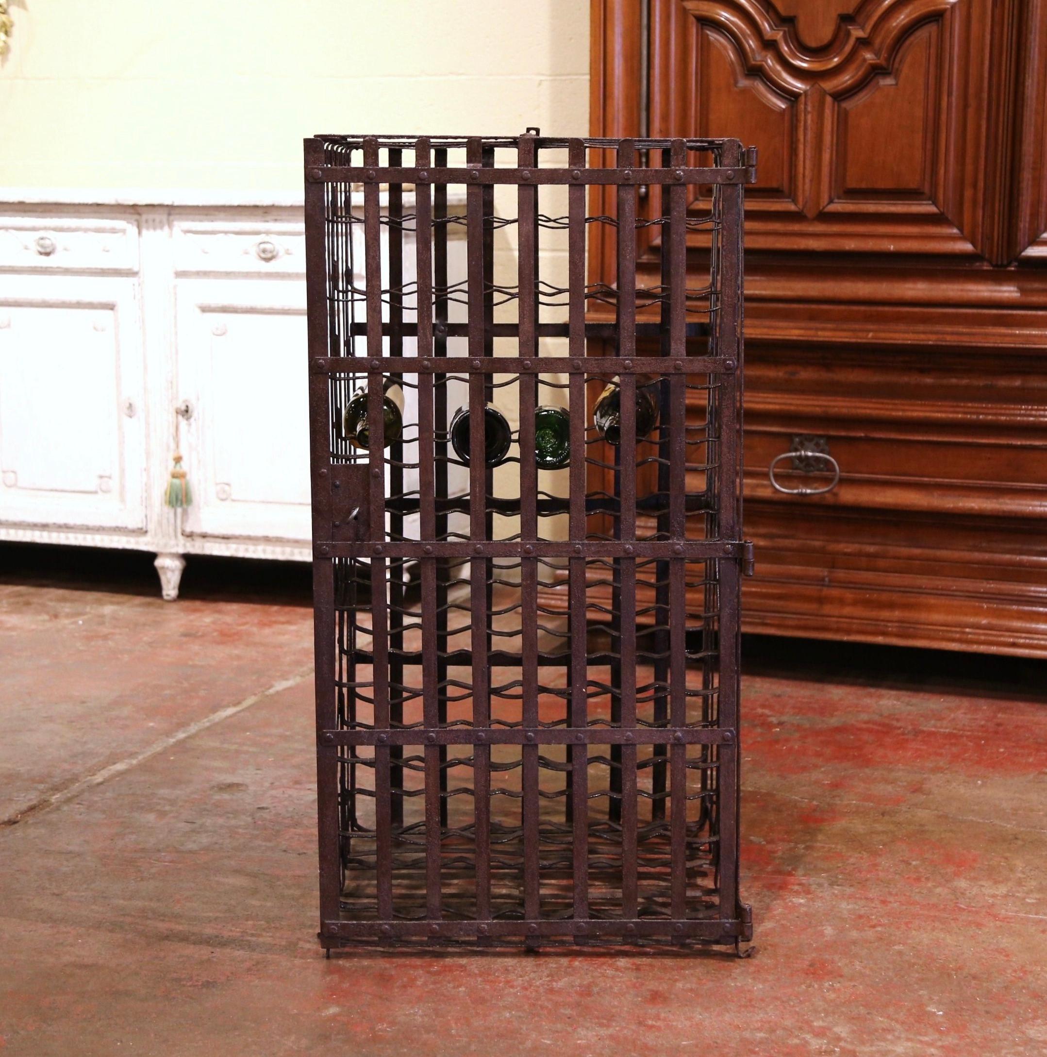 Decorate a wine cellar with this exquisite antique wine storage cage. Forged in the Burgundy region of France and rectangular in shape, the open cabinet with iron strap construction, features a large hinged door across the front with lock and key.