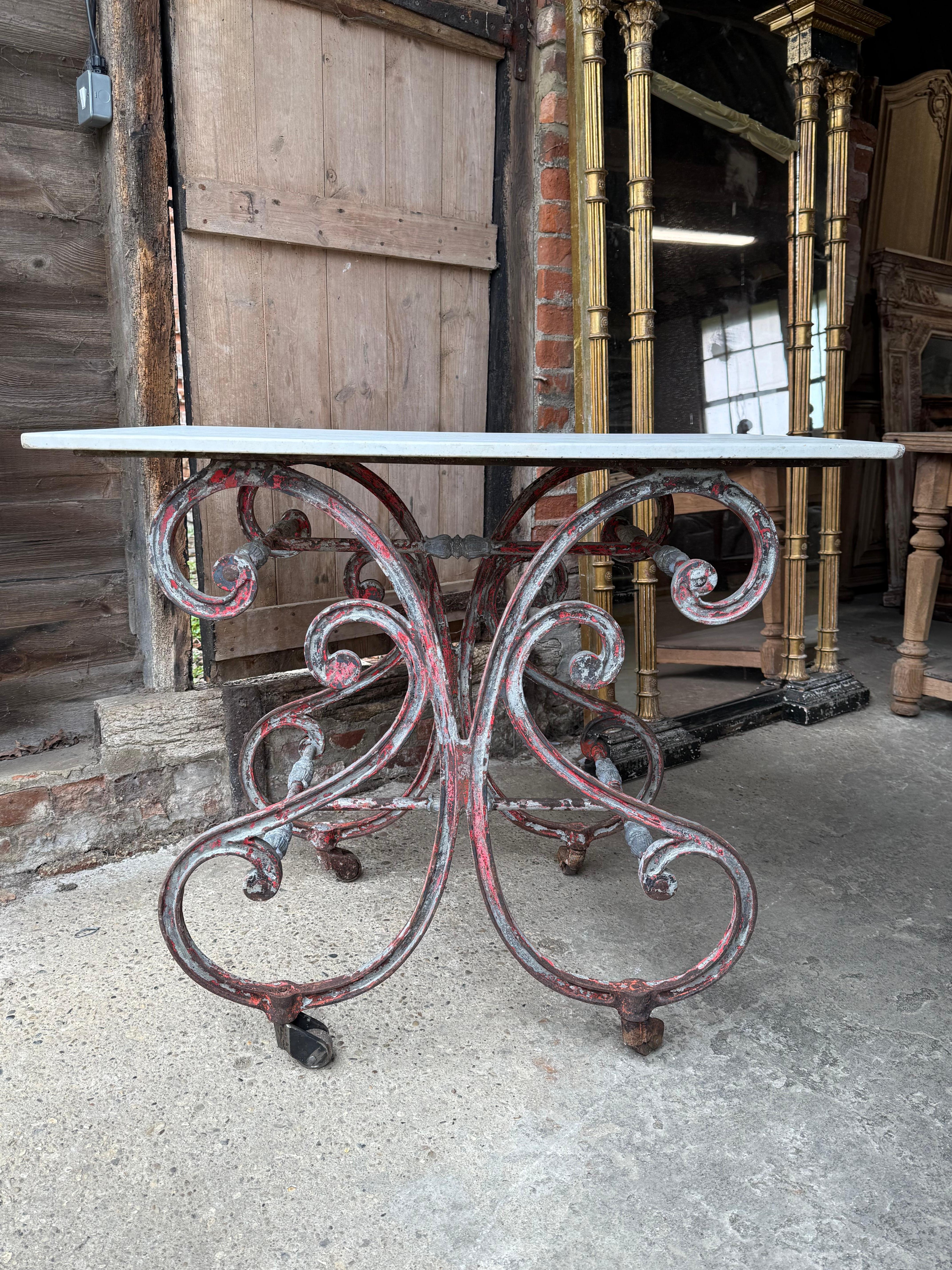 A wonderful late 19th century French butchers table from the south of France. Constructed in the Papillon style ((butterfly) with cast iron base and original marble top. Tables such as this one were originally used in the butchers shop to display
