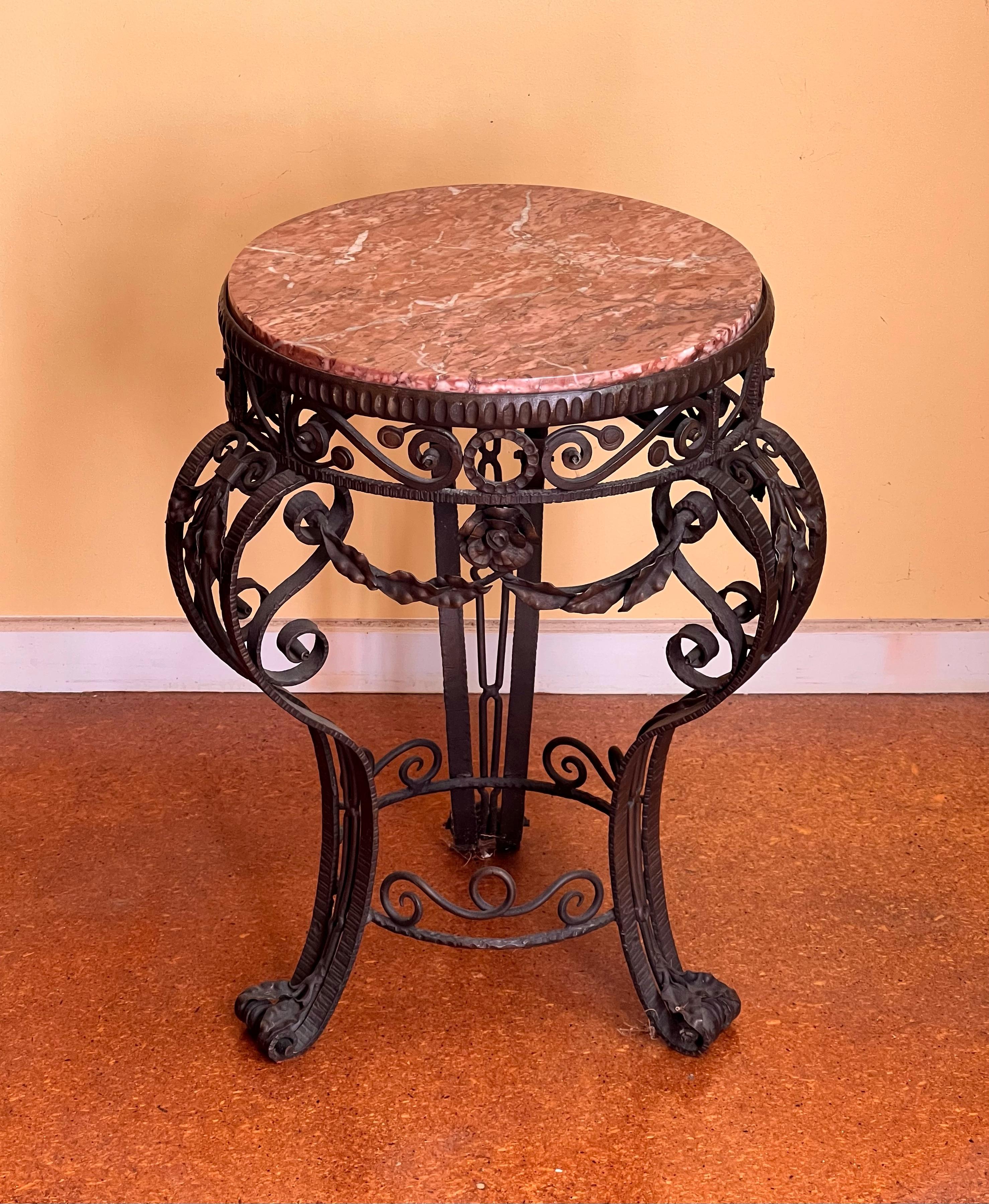 19th Century French Iron Marble Table. Circa 1890. Beautiful antique side / occasional table with detailed ironwork featuring a pink and brown-hued veined marble top.

Overall good antique condition. Light scratches to the marble top.

60cm